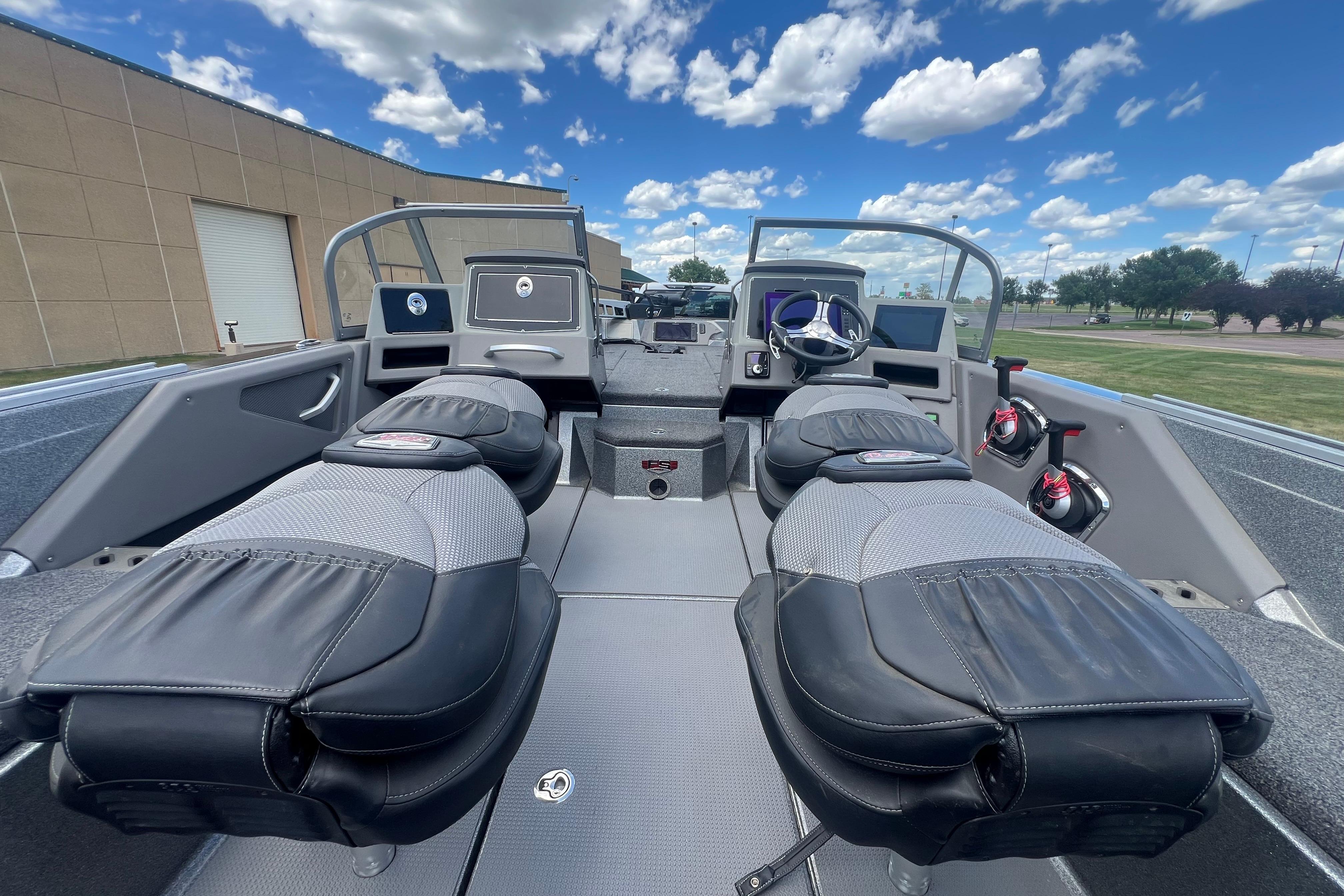 2023 Ranger 620FS Pro boat interior with dual consoles and seating under a blue sky.