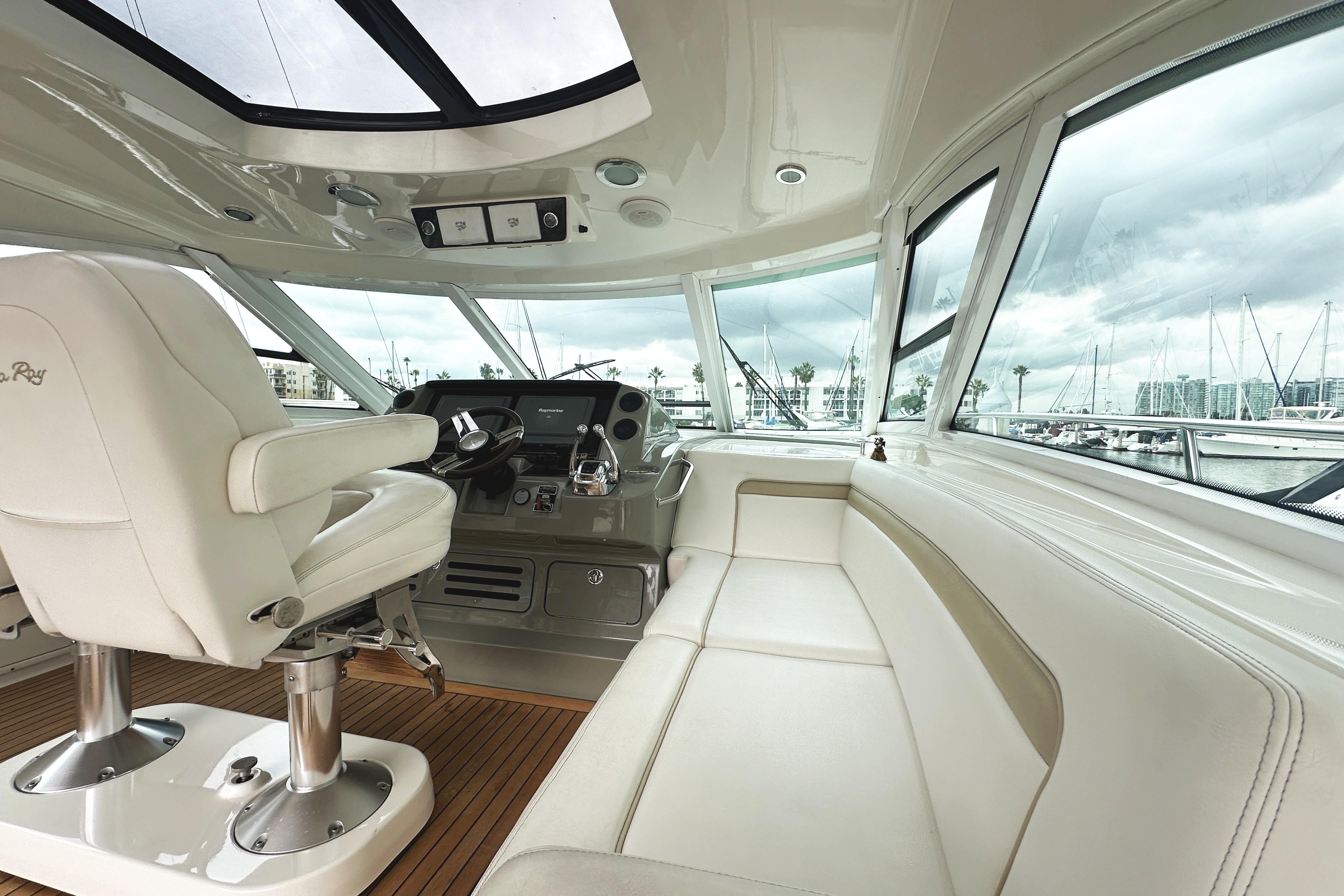 Luxurious interior of 2010 Sea Ray Sundancer 540 yacht with helm and seating area.