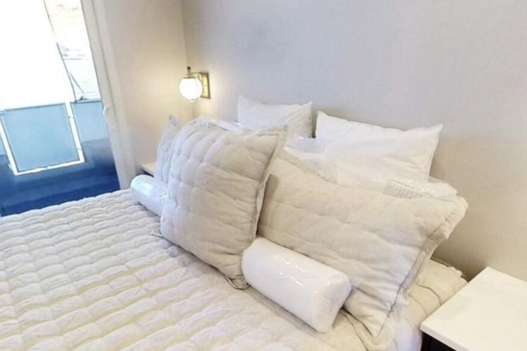 Cozy cabin bedroom on Adonia's Galileo Trip, featuring plush bedding and soft lighting, 2023.