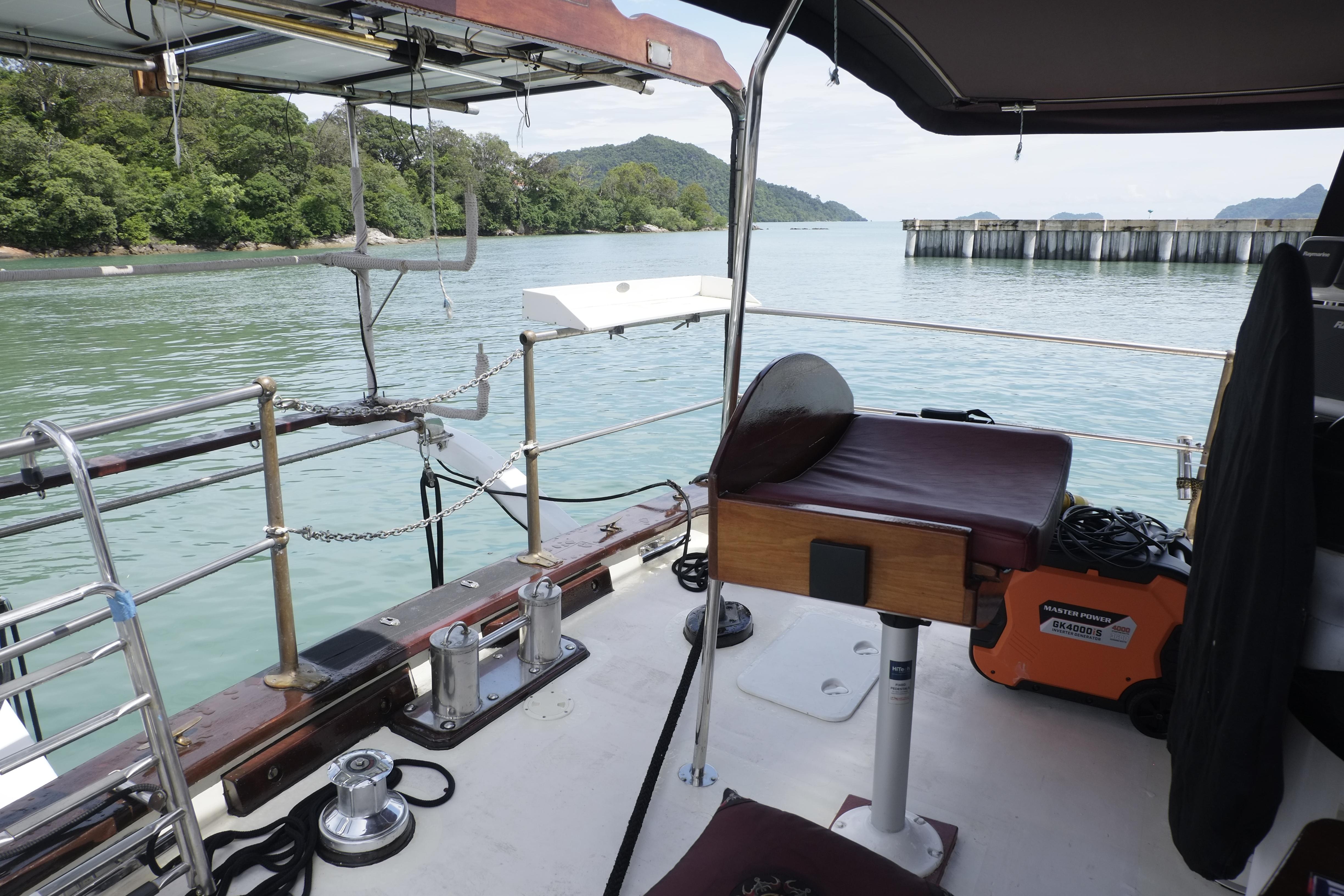 Deck view of 2006 Custom Bud Macintosh schooner, overlooking serene waters and lush greenery.