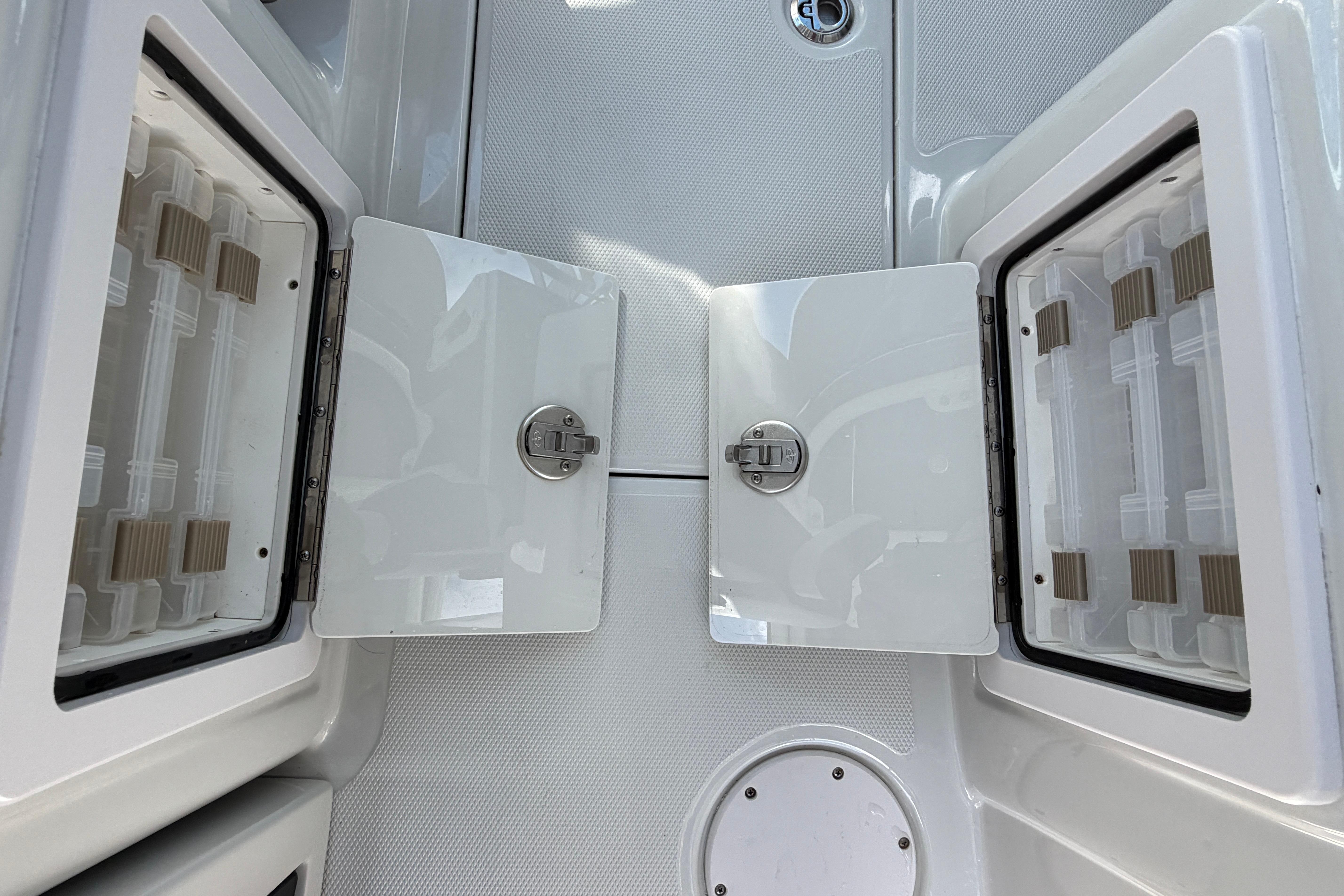 2024 Crownline 260 DC Finseeker storage compartments with open doors on deck.