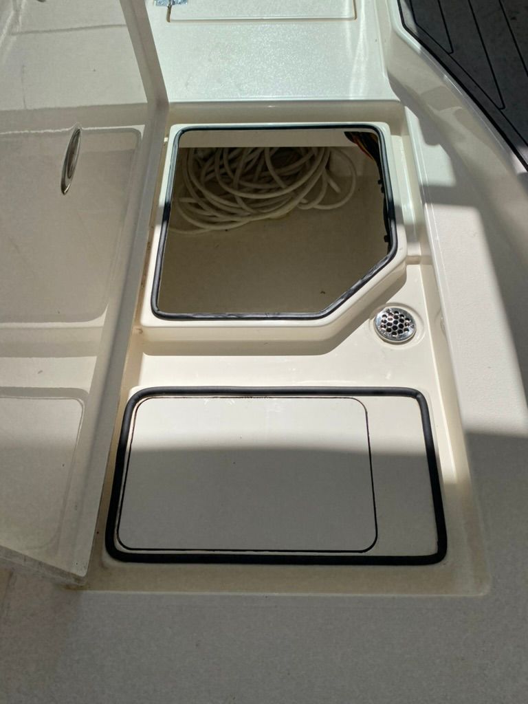 Storage compartment on a 2023 Cobia 330 boat.