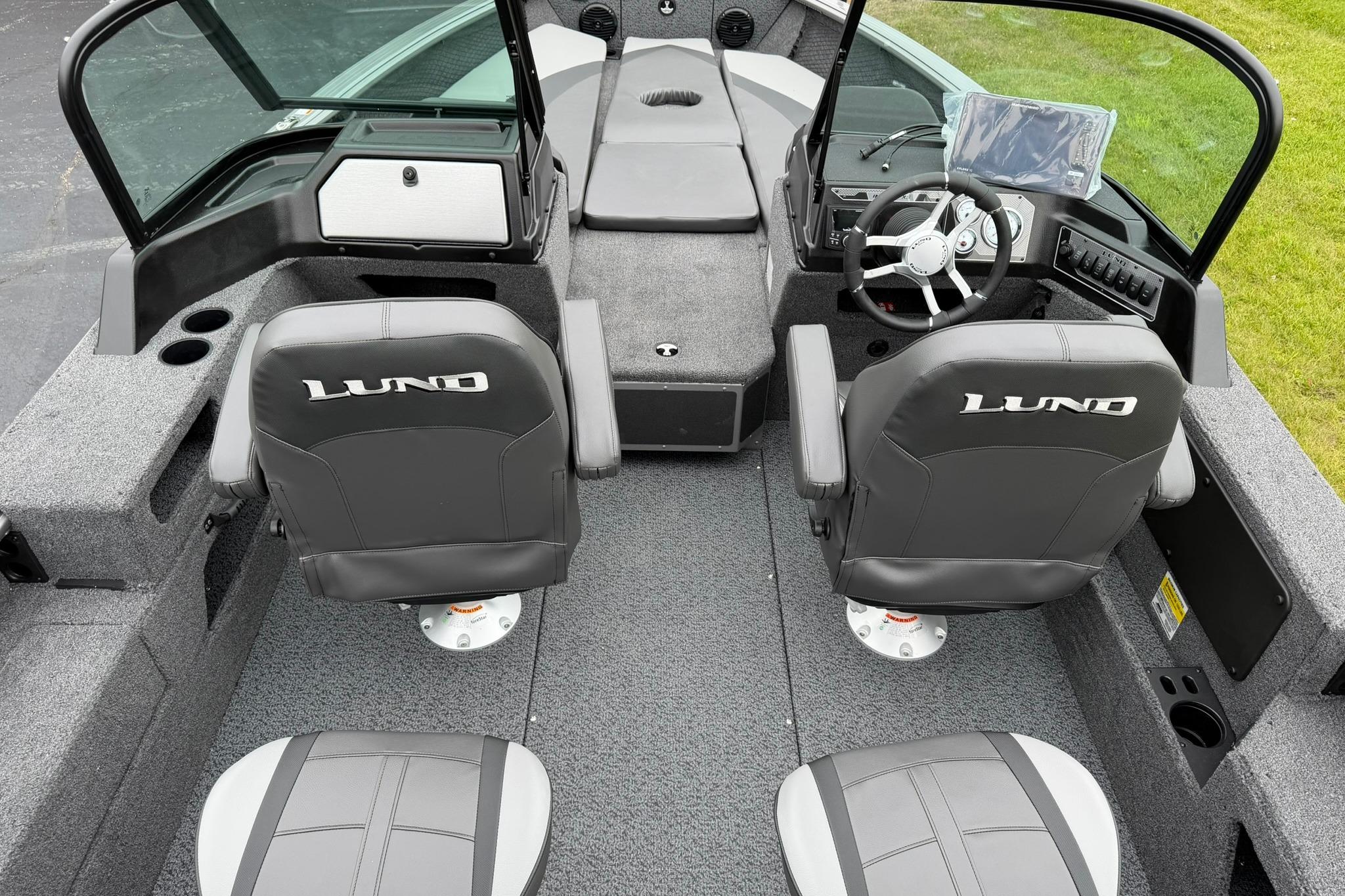 2027 Lund 2075 Impact XS boat interior with two seats and steering console.