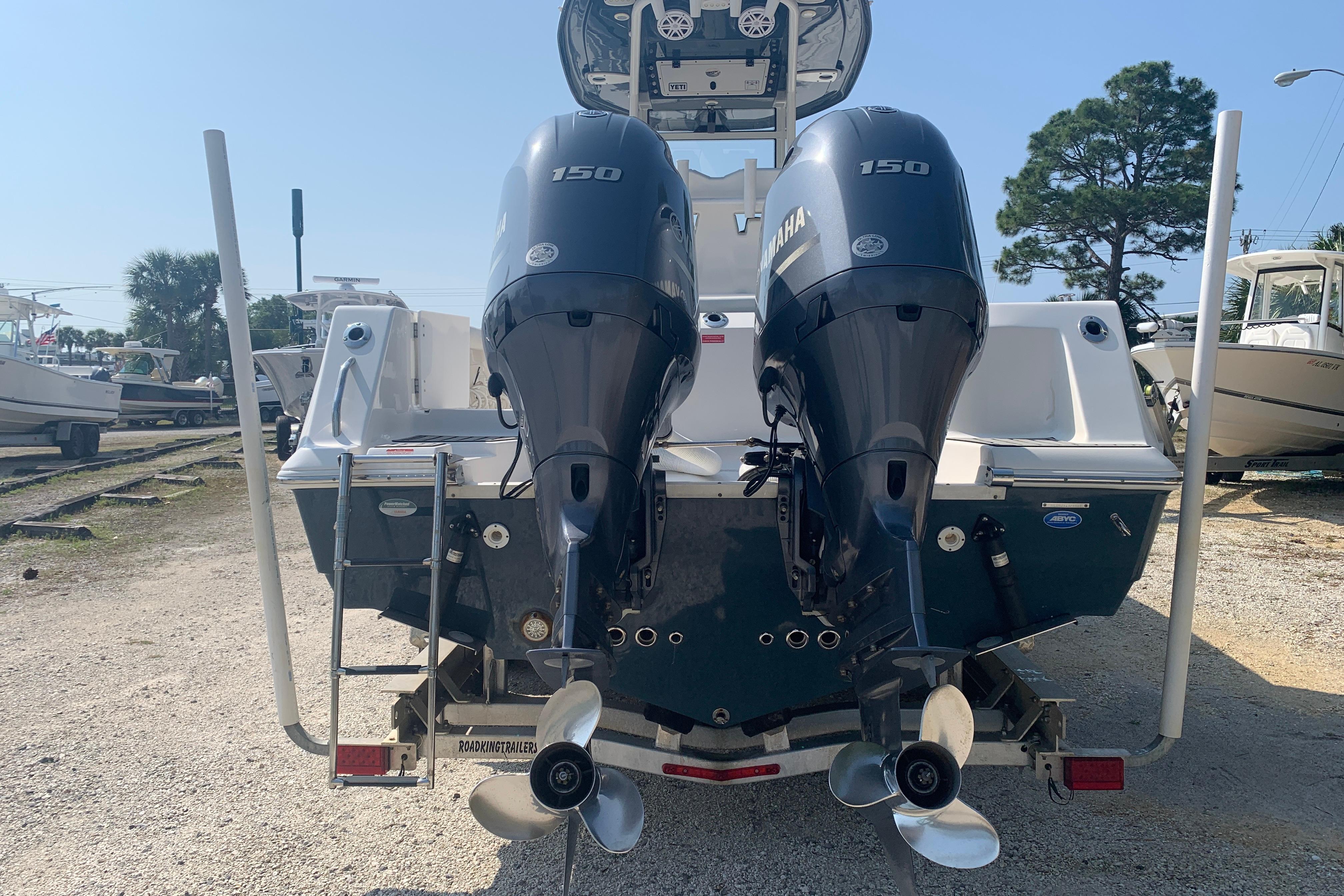 2021 Tidewater 256 CC Adventure boat with dual Yamaha 150 engines, rear view.