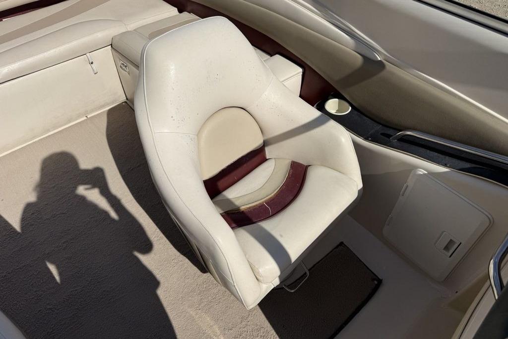 1999 Glastron GT 225 boat interior with white and maroon seating.