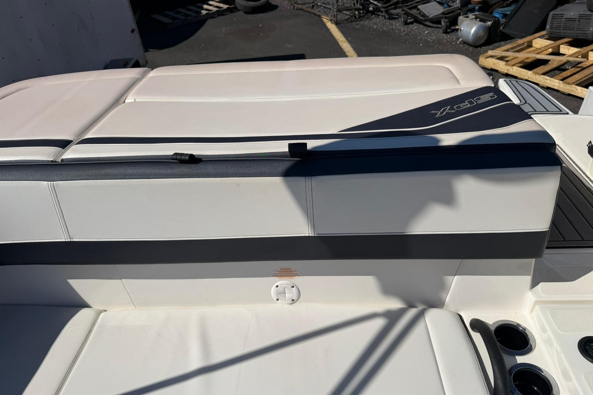 2016 Sea Ray SPX 210 boat interior with white seating and cup holders.