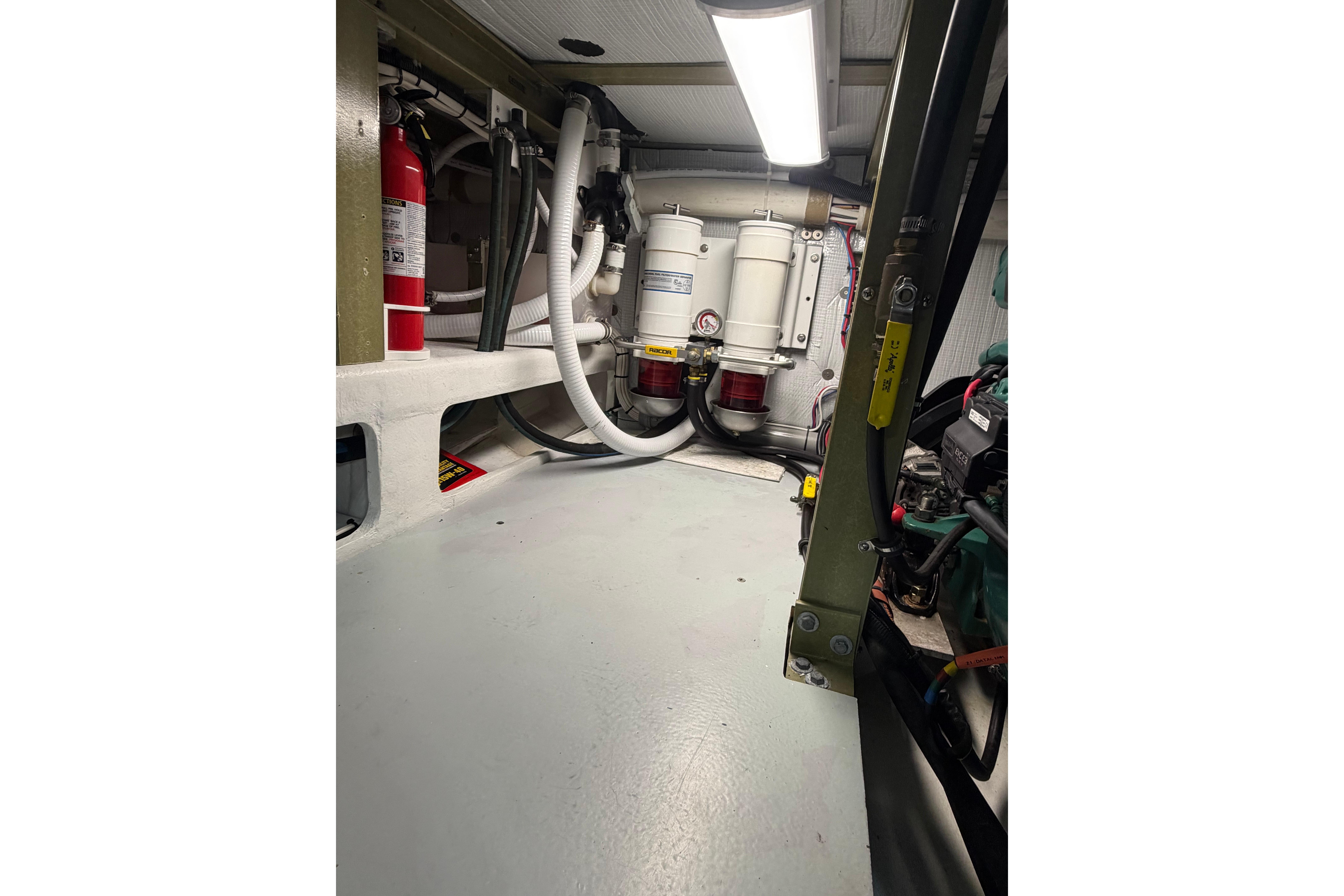 Engine room of 2018 H&H Marine Osmond Beal boat, featuring fire extinguisher and filtration system.