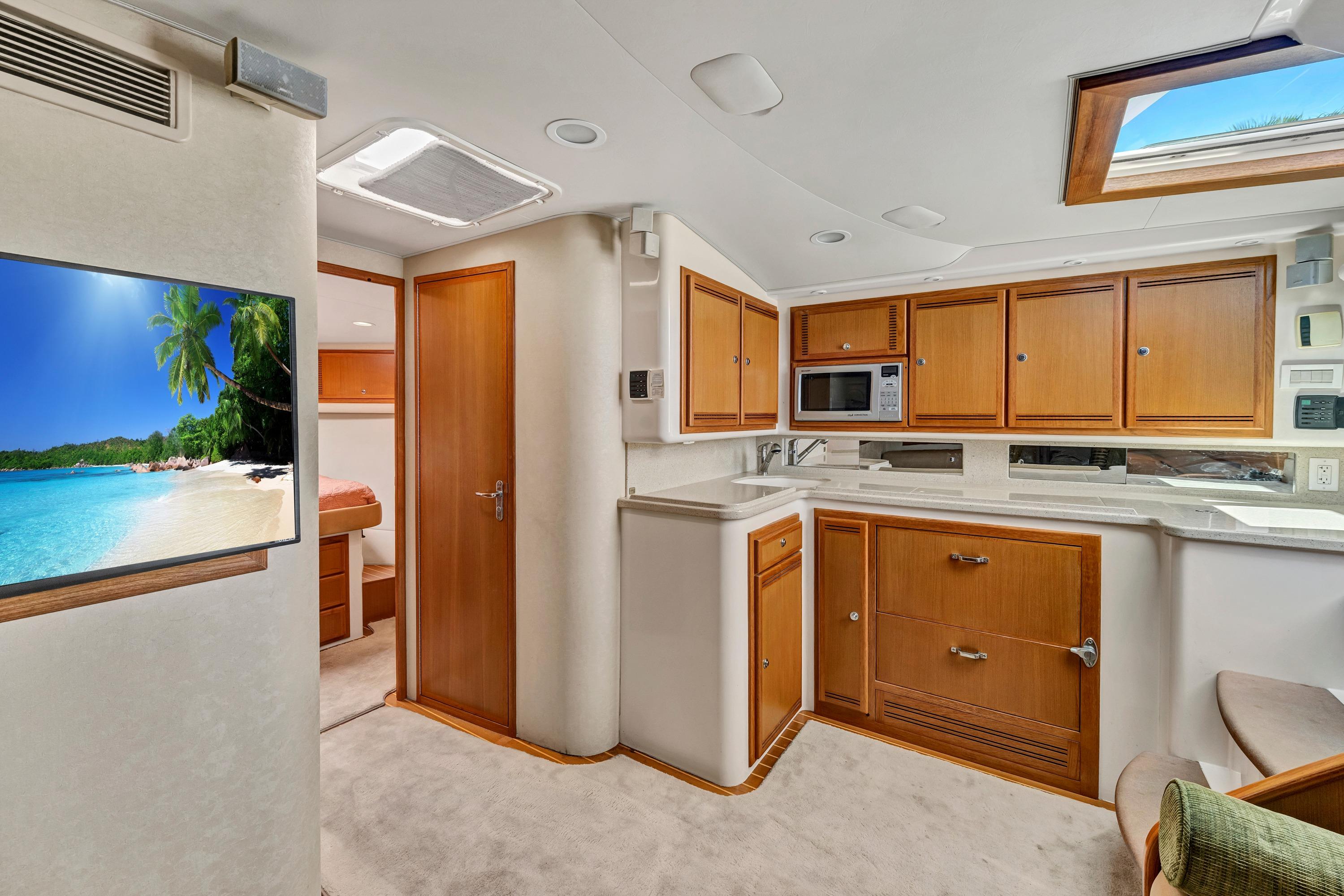 Luxurious 2010 Cabo 45 Express yacht interior with modern kitchen and cozy living space.
