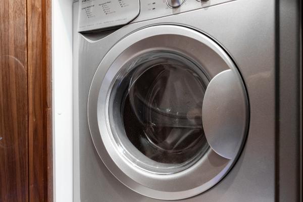 Front-loading washing machine on a 2021 Riviera 5400 Sport Yacht.