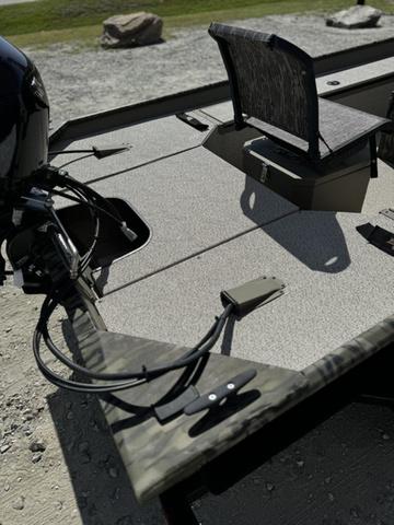 2024 SeaArk 31652 CRAPPIE boat with camo design and seating, parked on gravel.