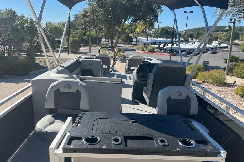 2026 Sun Tracker Fishin' Barge 22 DLX interior with seating and fishing amenities.