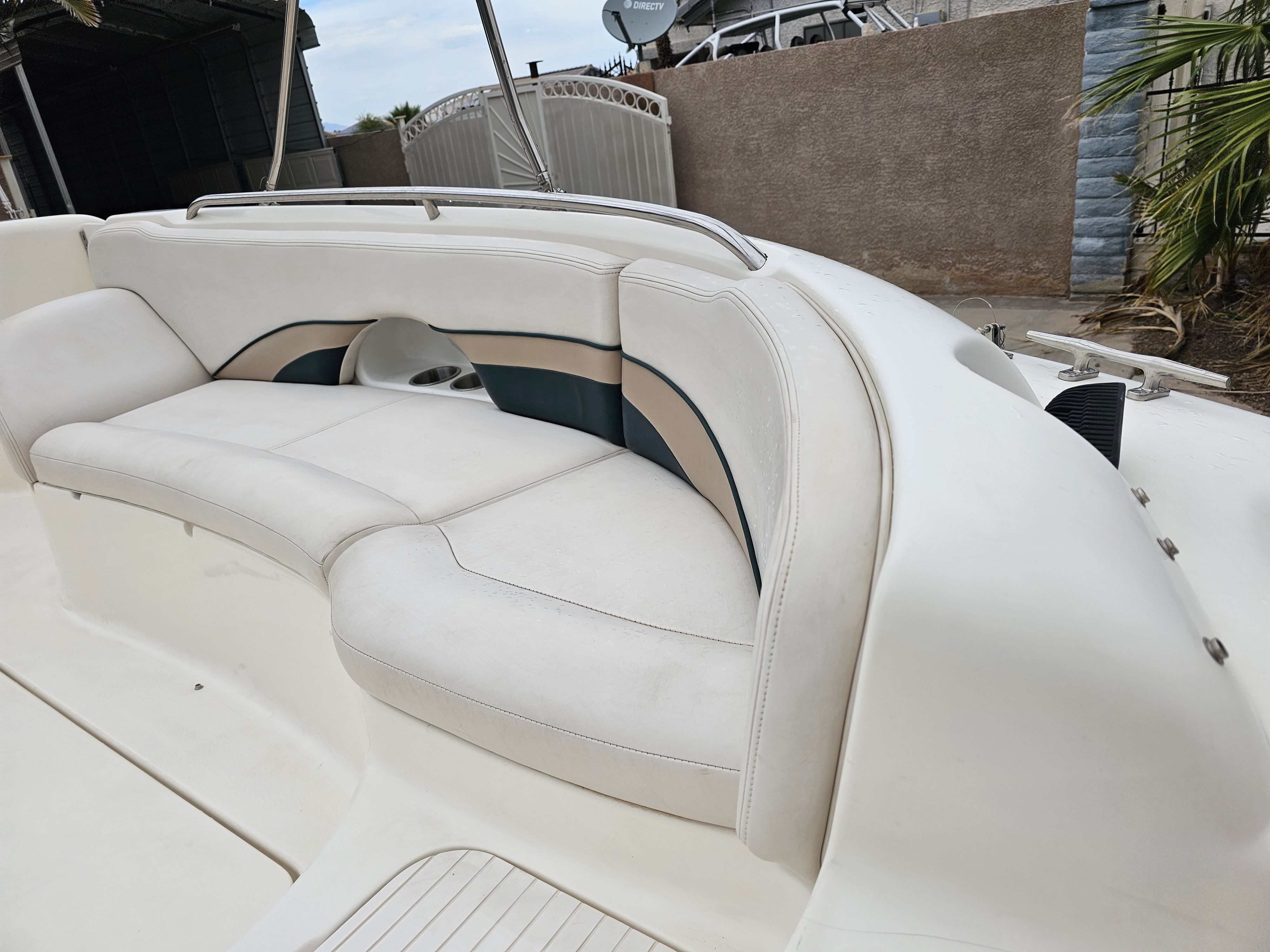 1998 Chaparral Sunesta 252 boat with white seating area.