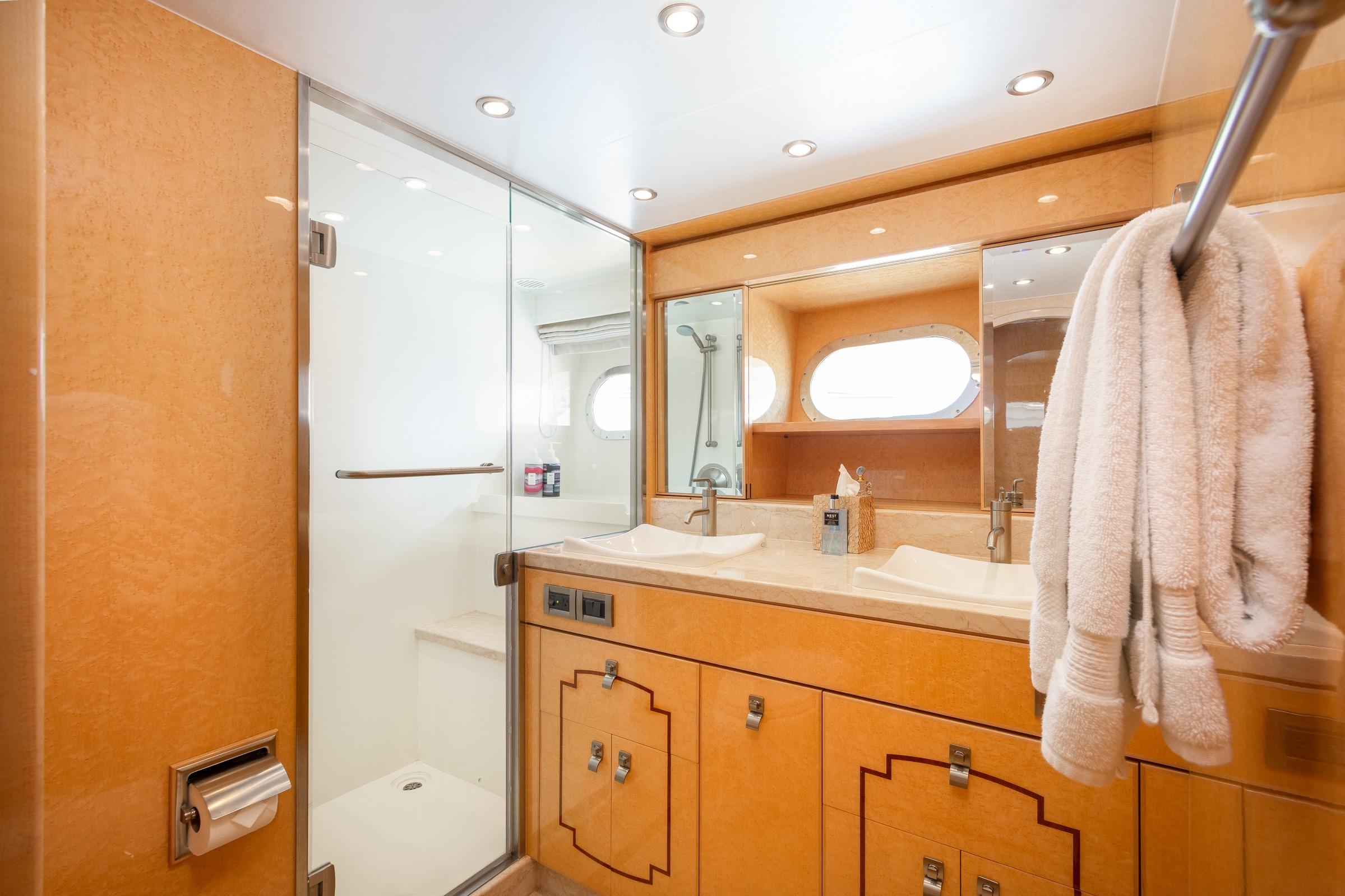 Luxurious bathroom in 2014 Hargrave Sky Lounge yacht with dual sinks and glass shower.