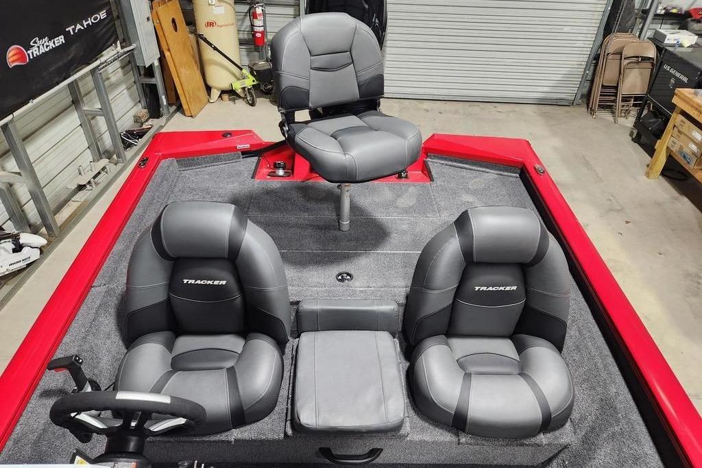 2026 Tracker Pro Team 175 boat interior with gray seating and red accents in a garage.