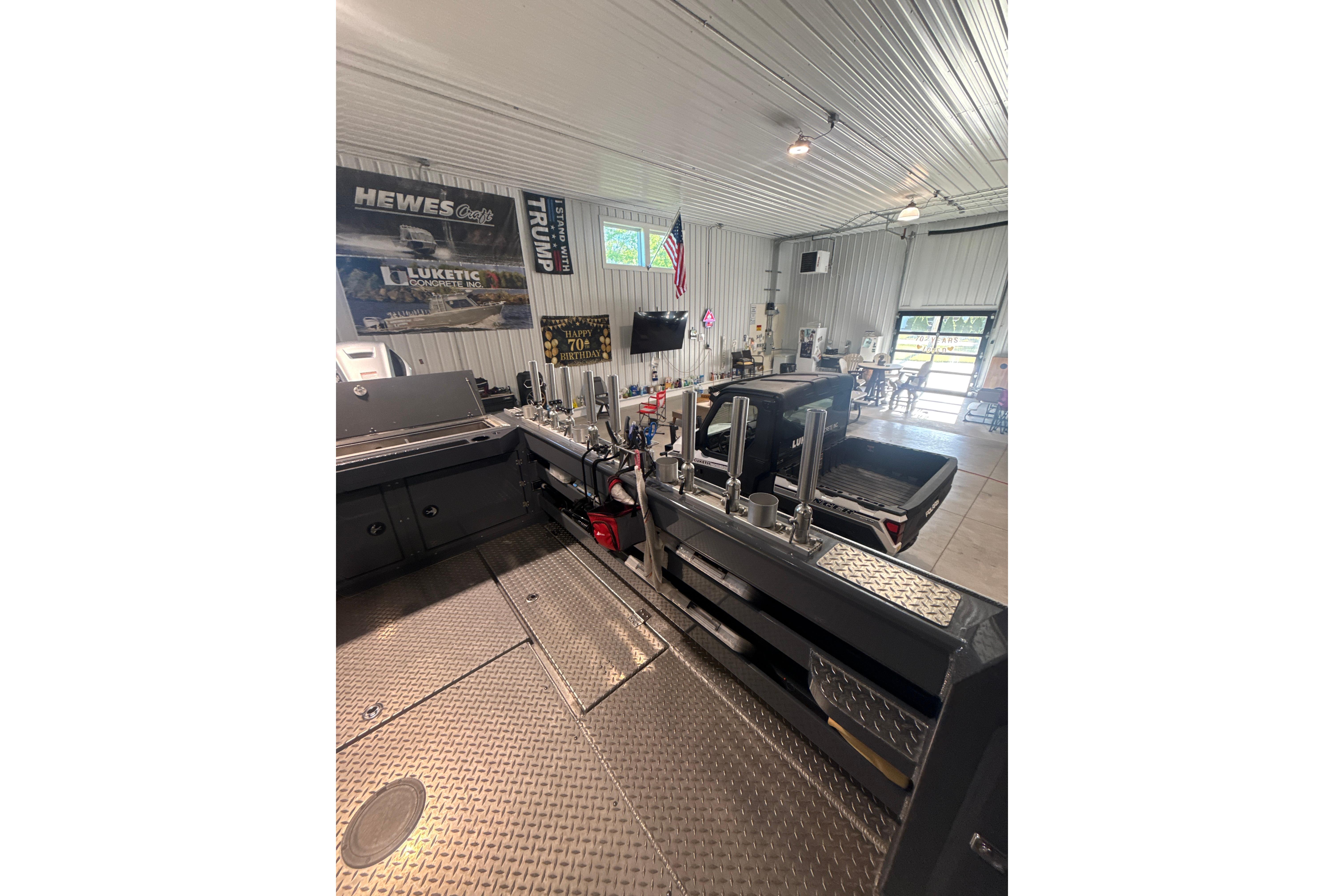 Interior of a 2022 Hewescraft 270 Alaskan Hardtop in a spacious garage setting.