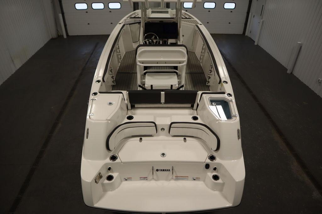 2026 Yamaha Boats 255 FSH Sport E, sleek design, spacious interior, in a showroom setting.