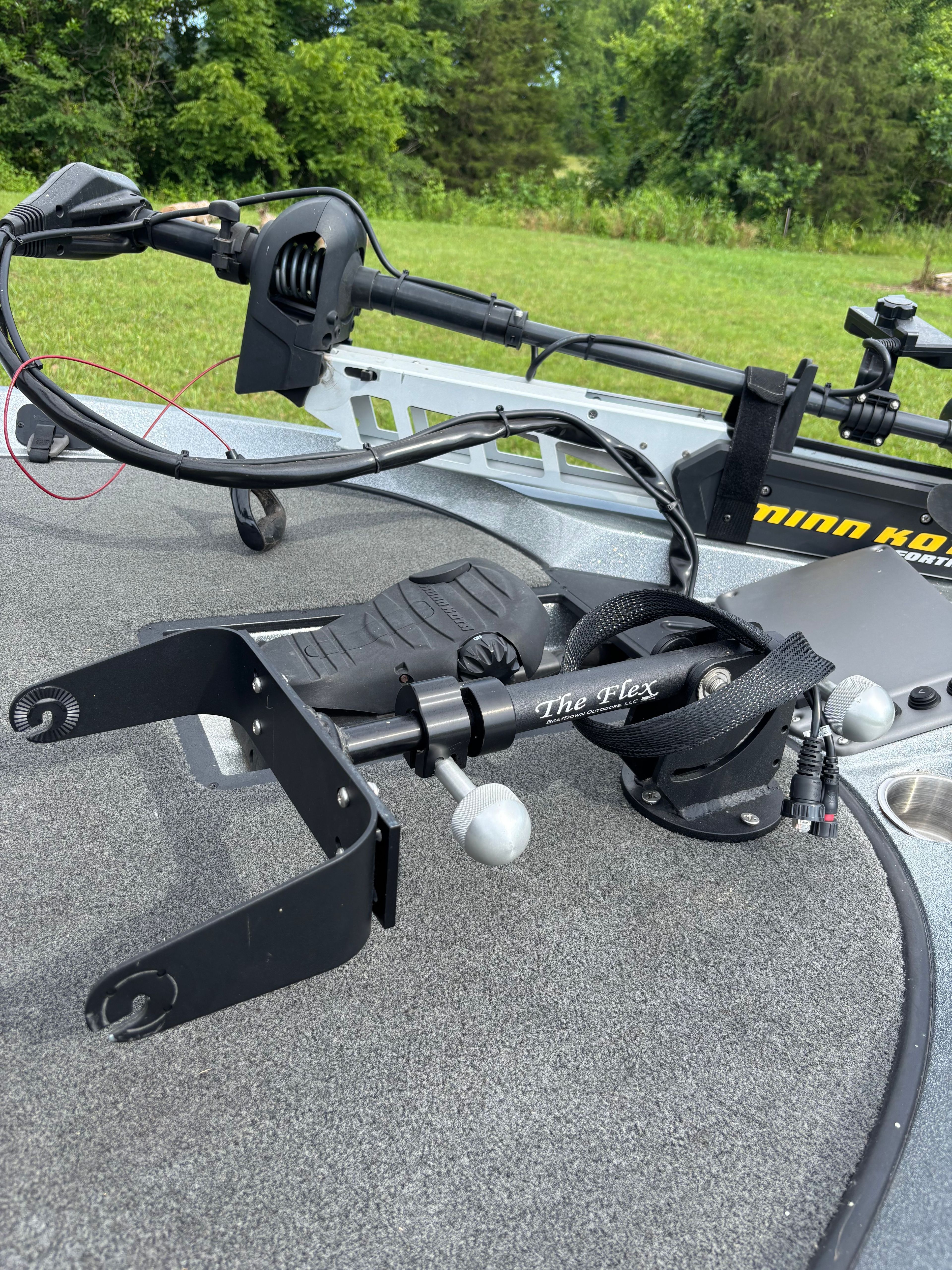 Close-up of a boat deck with fishing gear and a motor.