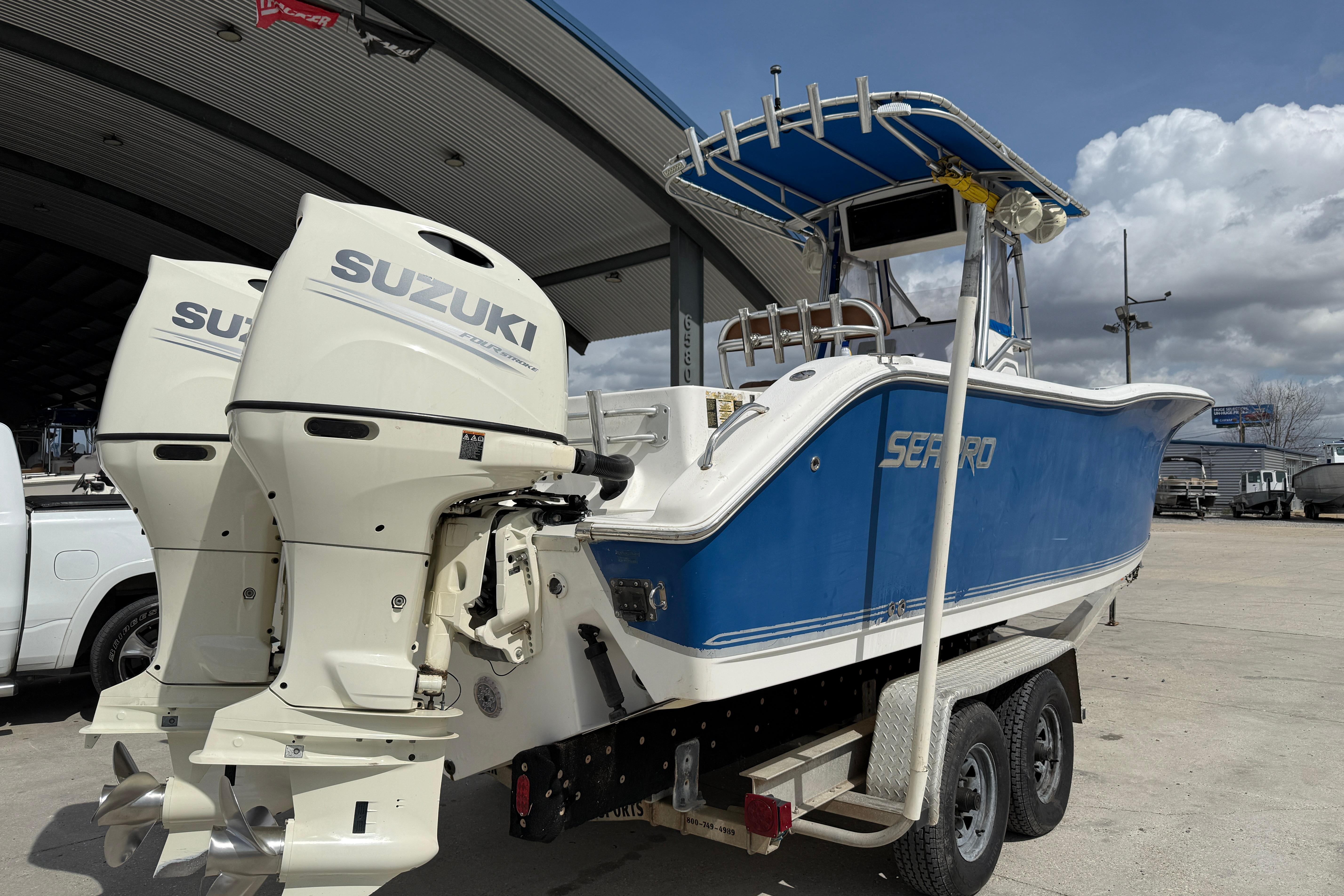 2007 Sea Pro 270 Center Console boat with Suzuki outboard motors on a trailer.