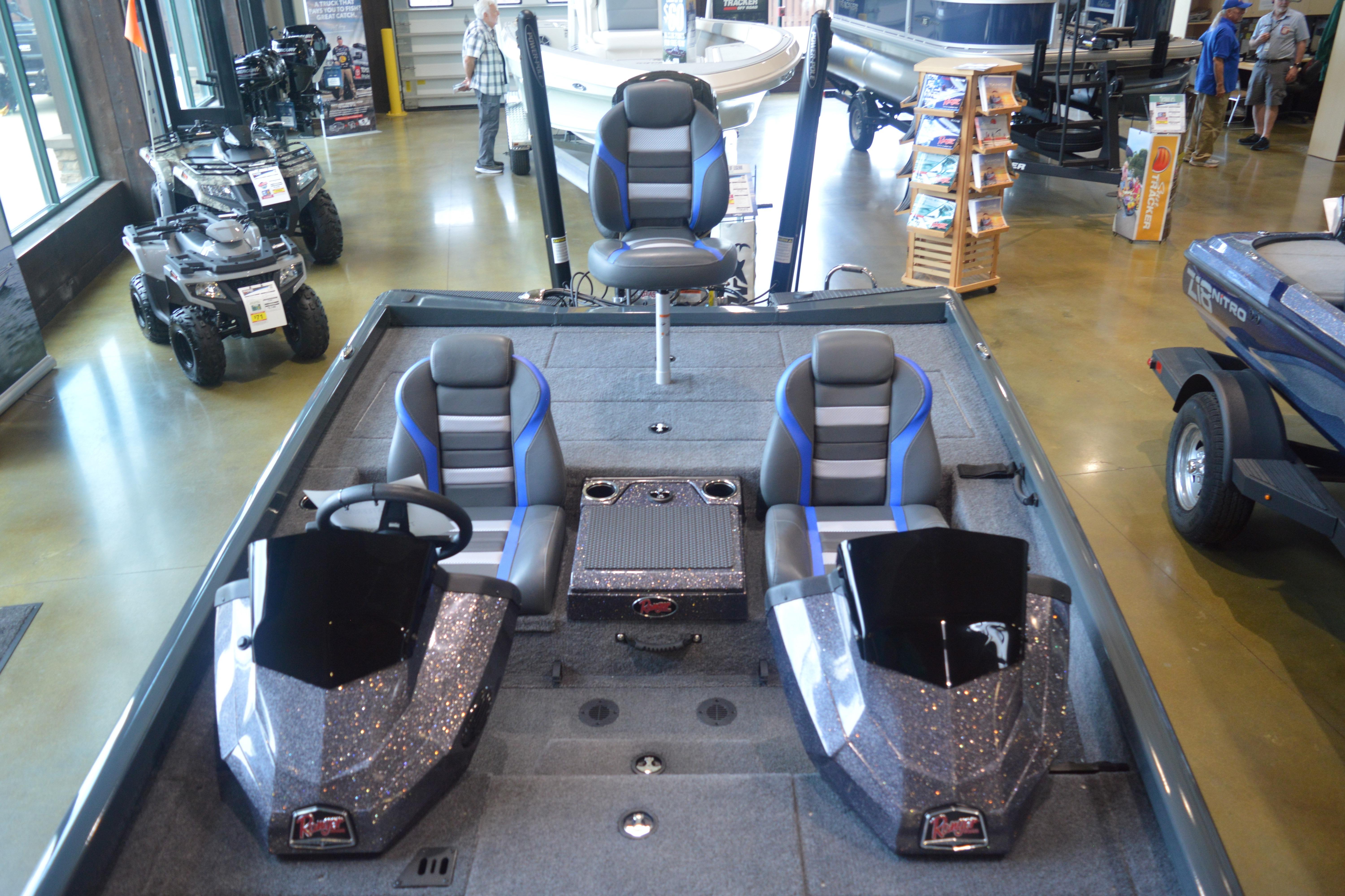 2026 Ranger RT188P fishing boat interior with seating and control console in showroom.