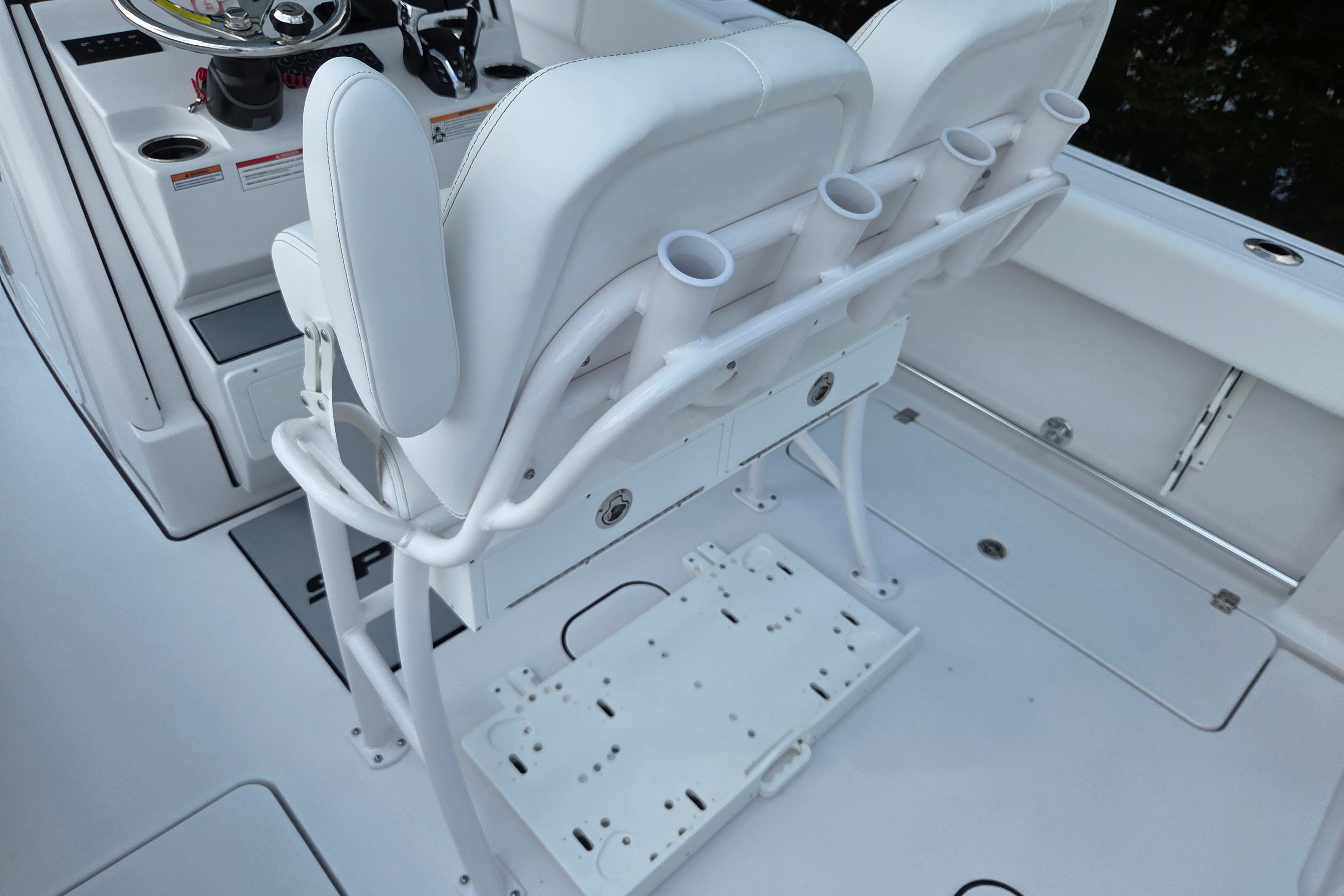 2026 Sportsman Open 252 Center Console boat interior with white seating and rod holders.