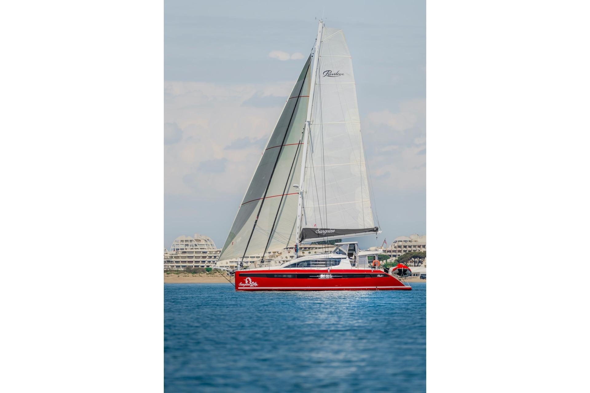 Red Privilege Signature 510 yacht sailing on calm waters, year 2025.