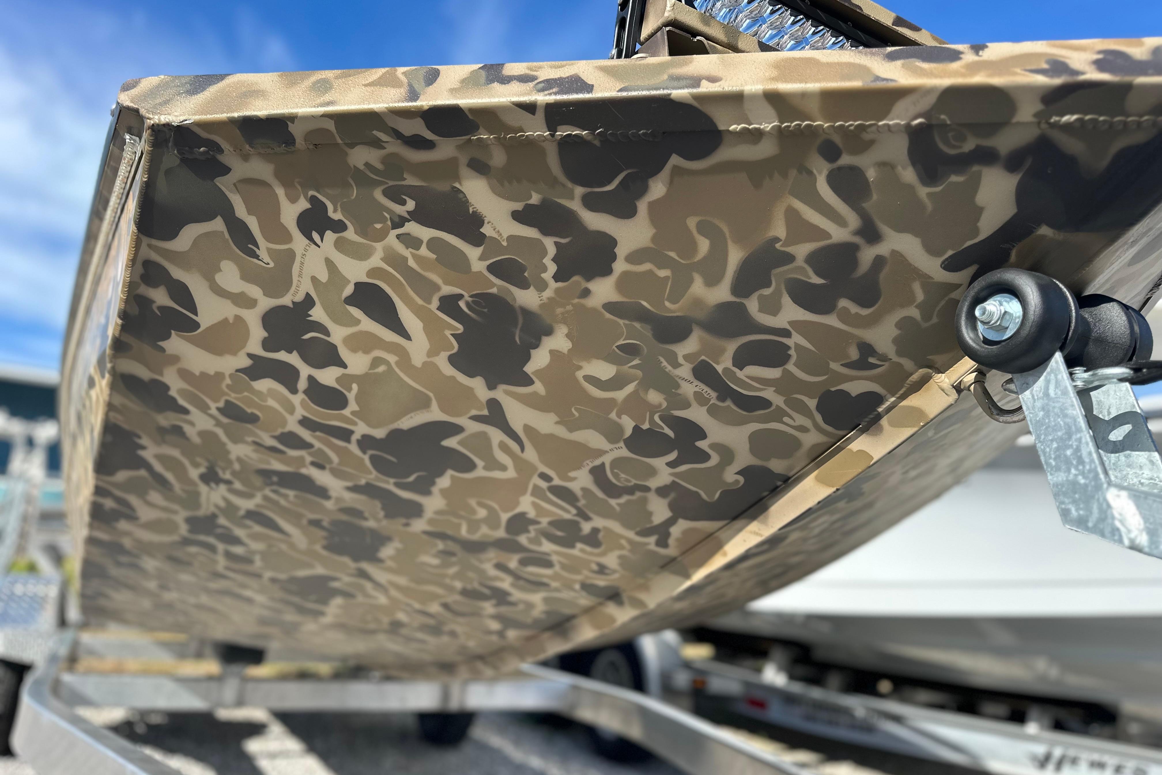 Camouflage-patterned hull of 2026 Excel 1751 Viper F4 boat on trailer.