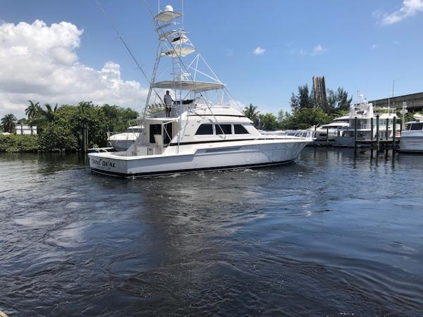 1997 Bertram Convertible yacht on a sunny day in a marina.