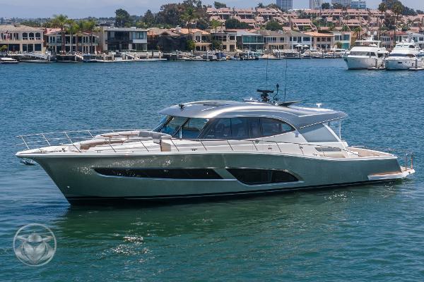 2025 Riviera 645 SUV luxury yacht cruising in a marina.