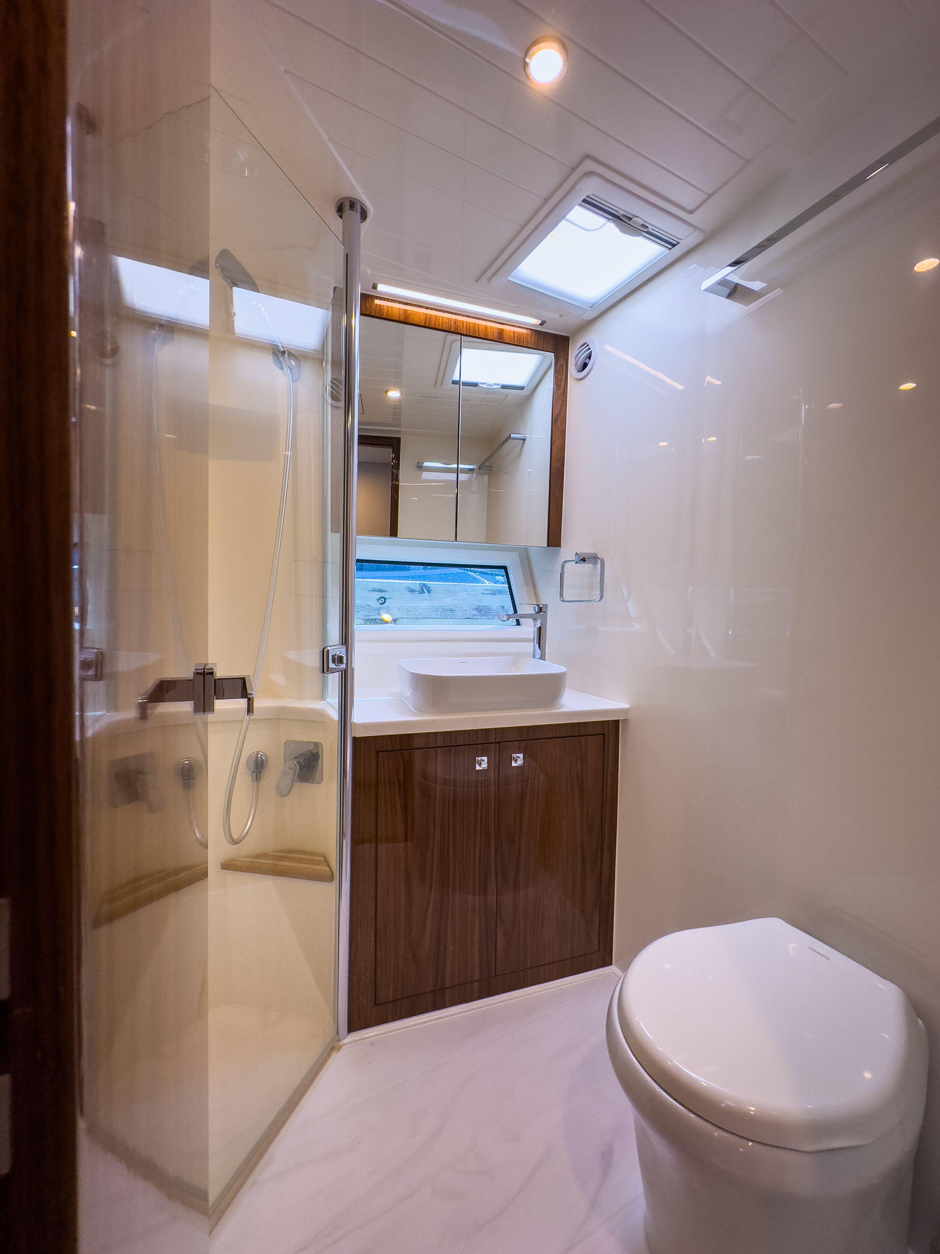 Luxurious bathroom in 2024 Riviera 465 SUV yacht with modern fixtures and elegant design.