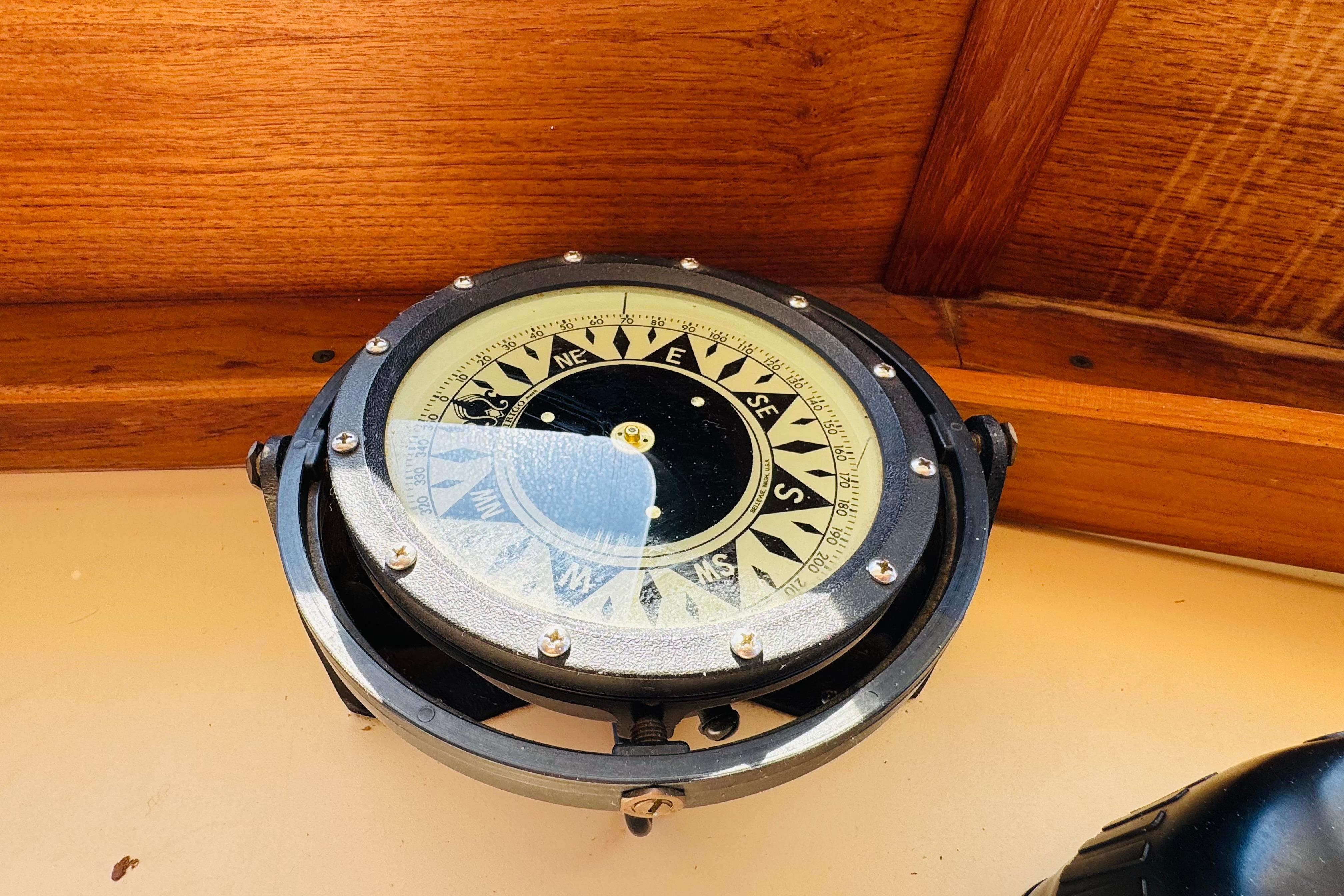 Compass on a 1996 Nordic Tug 32, mounted on a wooden dashboard.