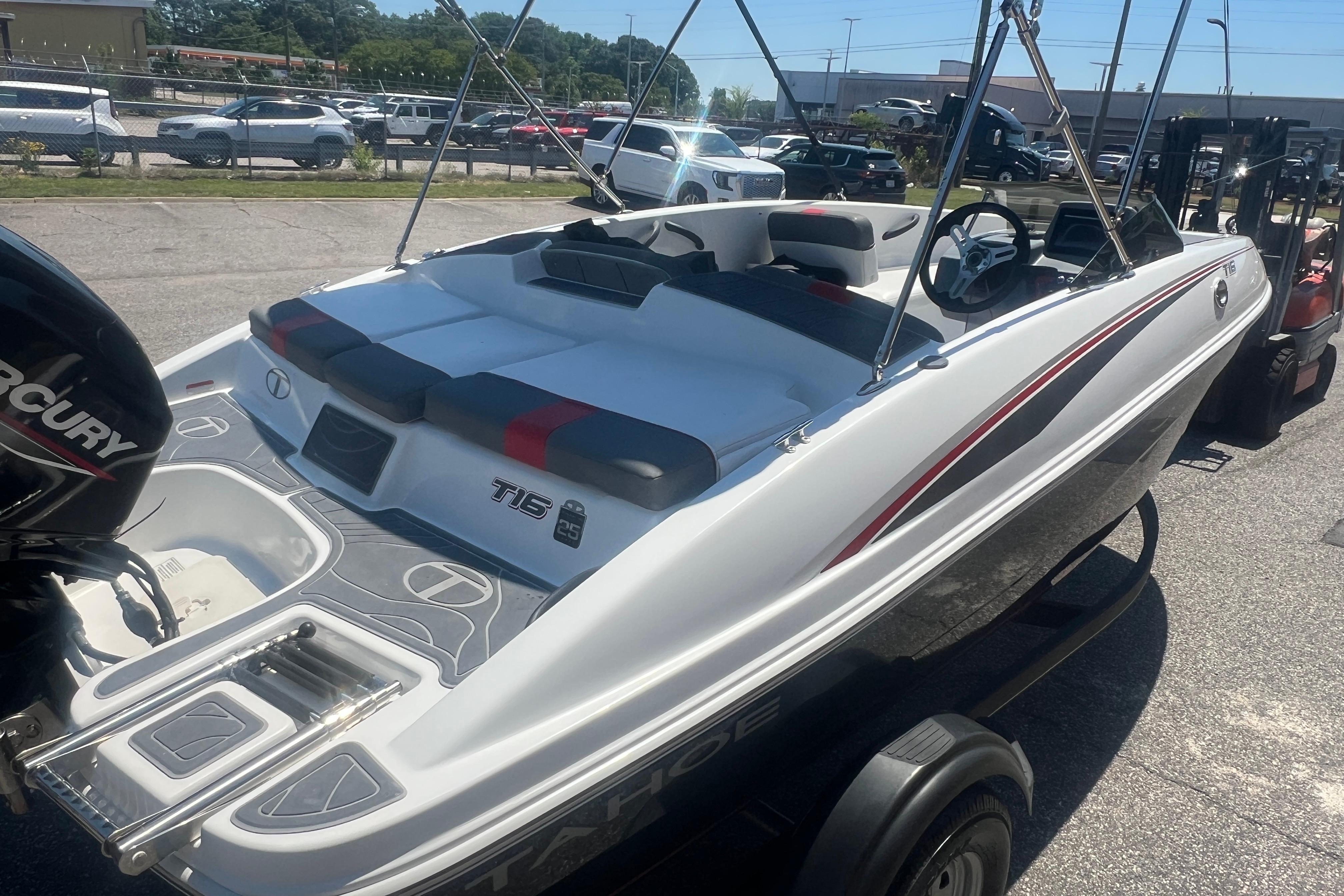 2023 Tahoe T16 boat with sleek design, parked outdoors, featuring a Mercury engine.