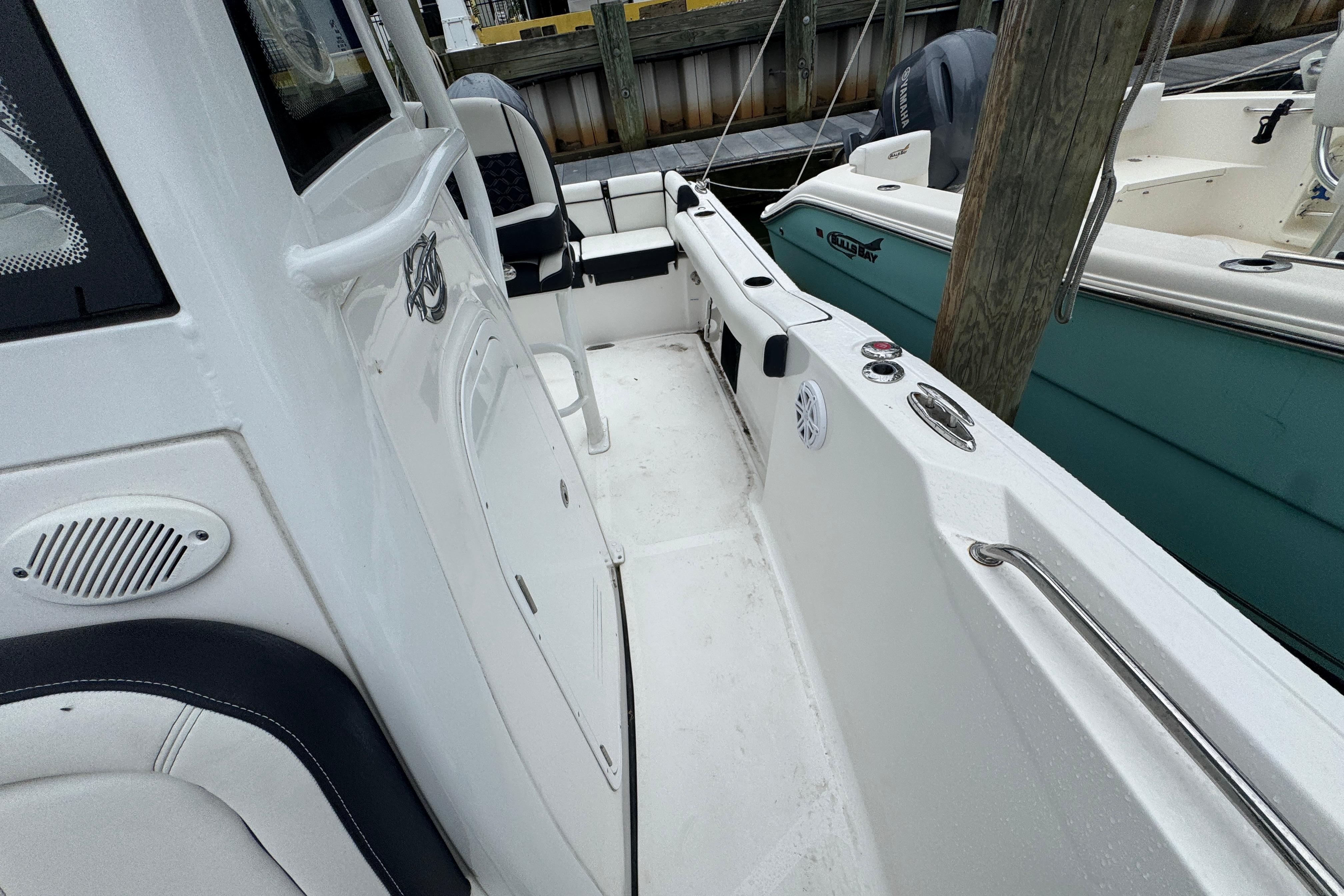 2022 Tidewater 232 SS boat interior, featuring sleek white design and comfortable seating.