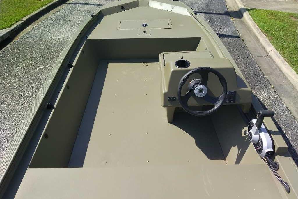 2026 Tracker Grizzly 1648 SC boat interior with steering wheel and control panel.