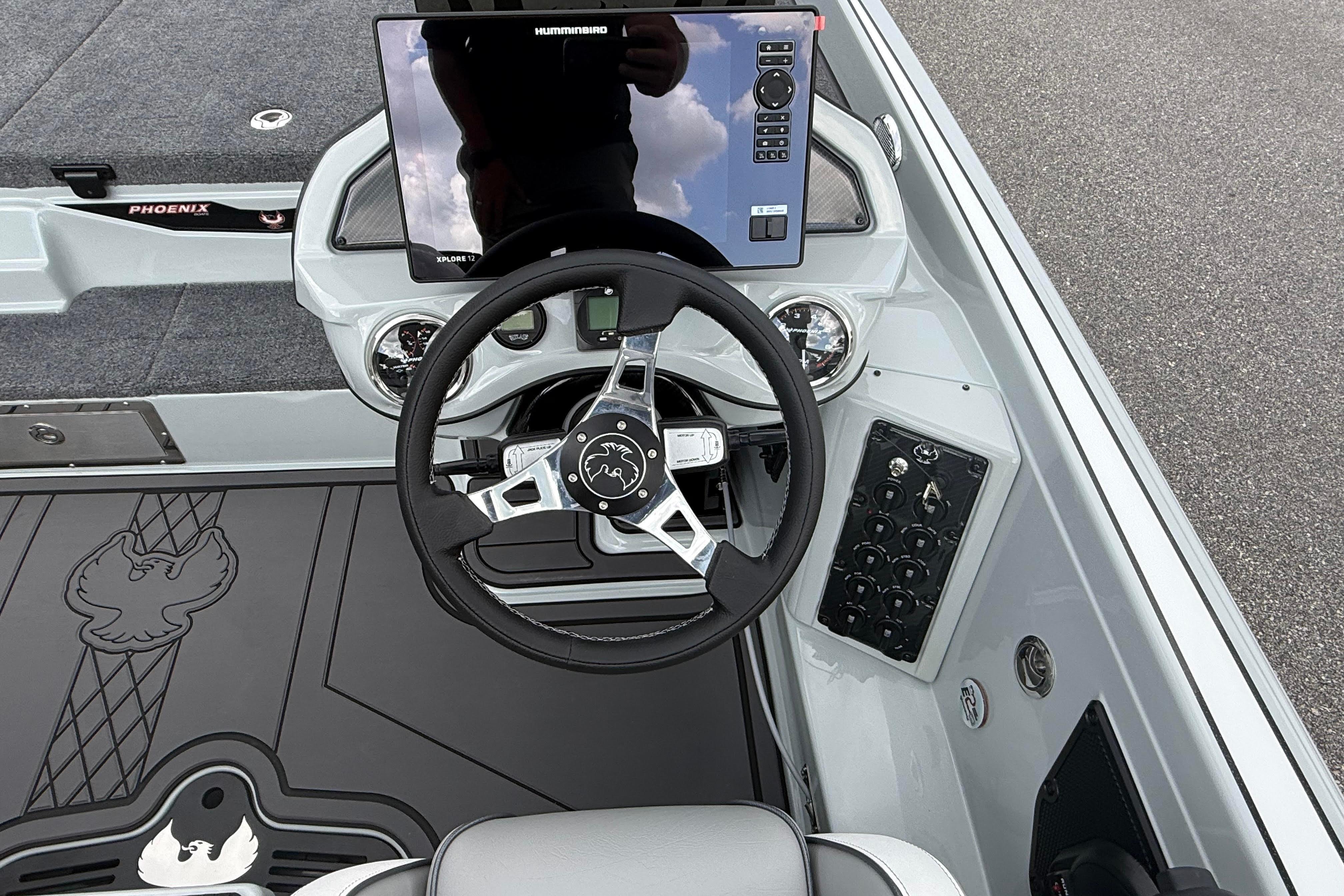 2027 Phoenix 921 Elite X II boat dashboard with steering wheel and control panel.