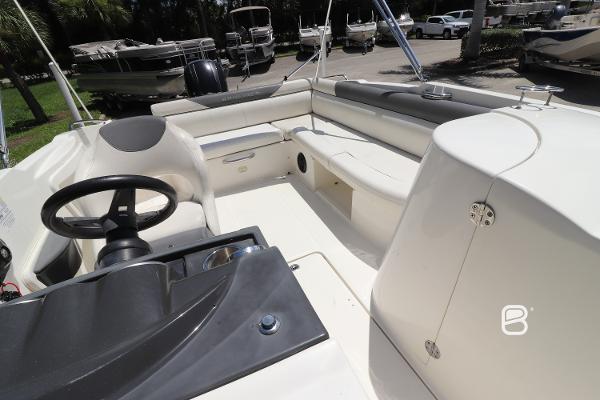 2018 Bayliner 210 DB boat interior with steering wheel and seating area.