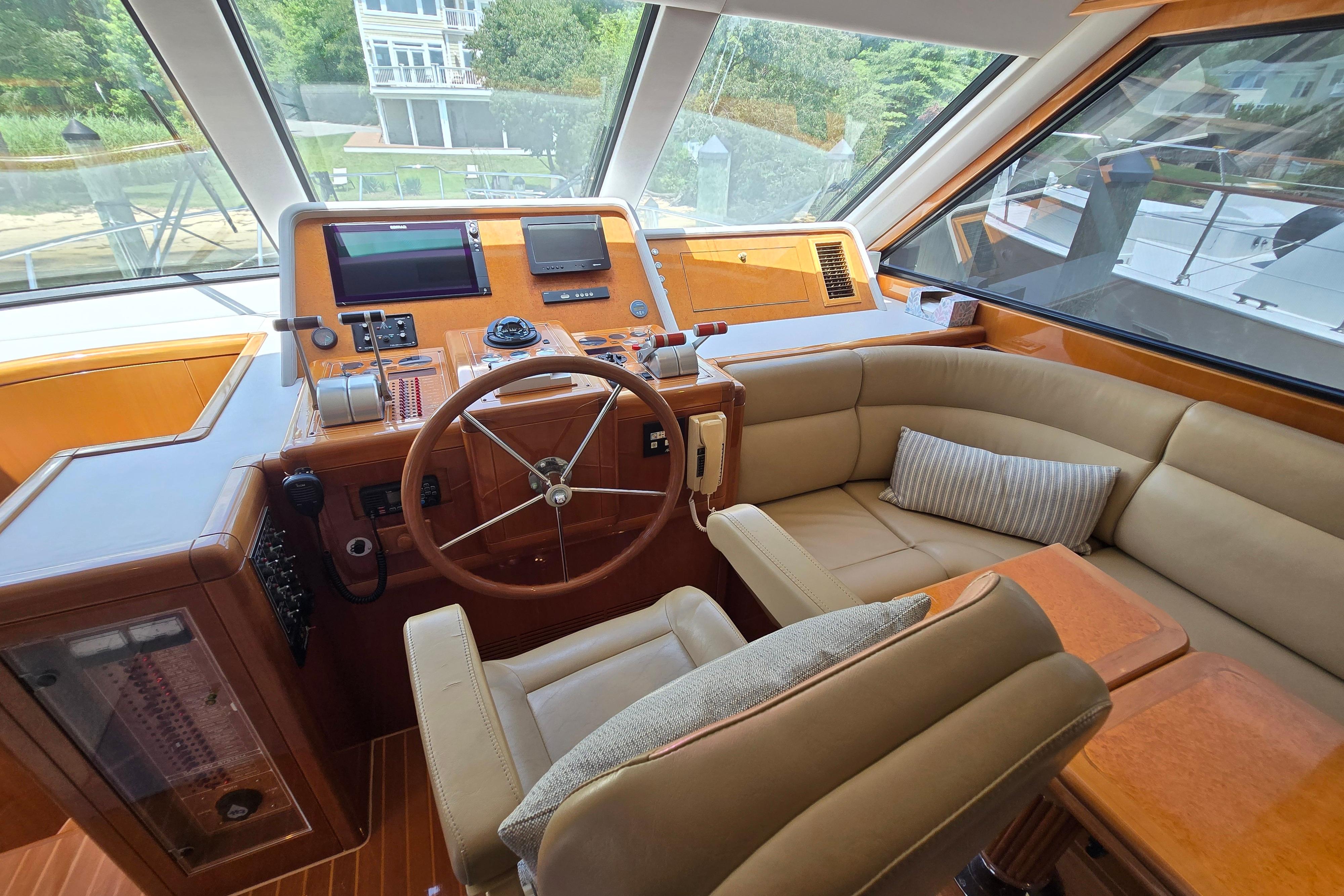 Luxurious 2004 Grand Harbour 58 yacht helm with leather seating and modern controls.