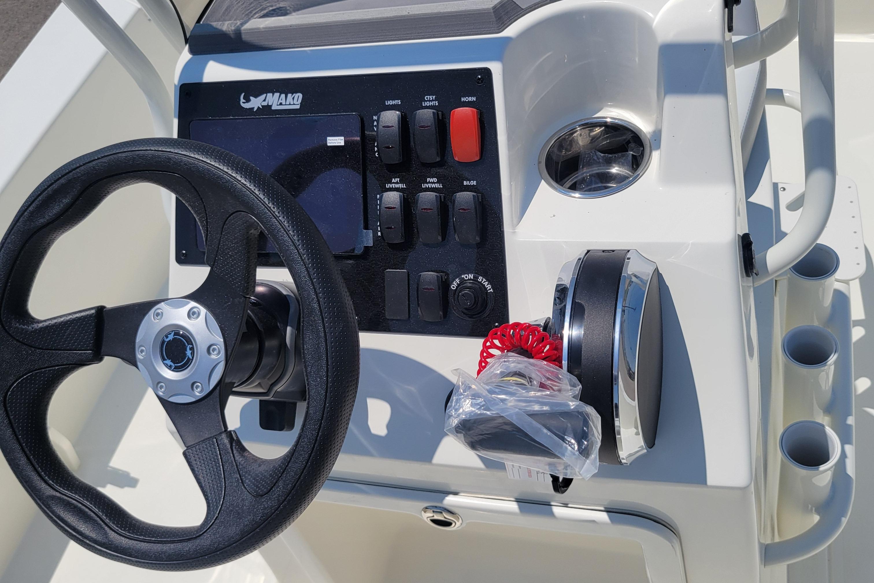 2026 Mako 18 Pro Skiff boat console with steering wheel and control panel.
