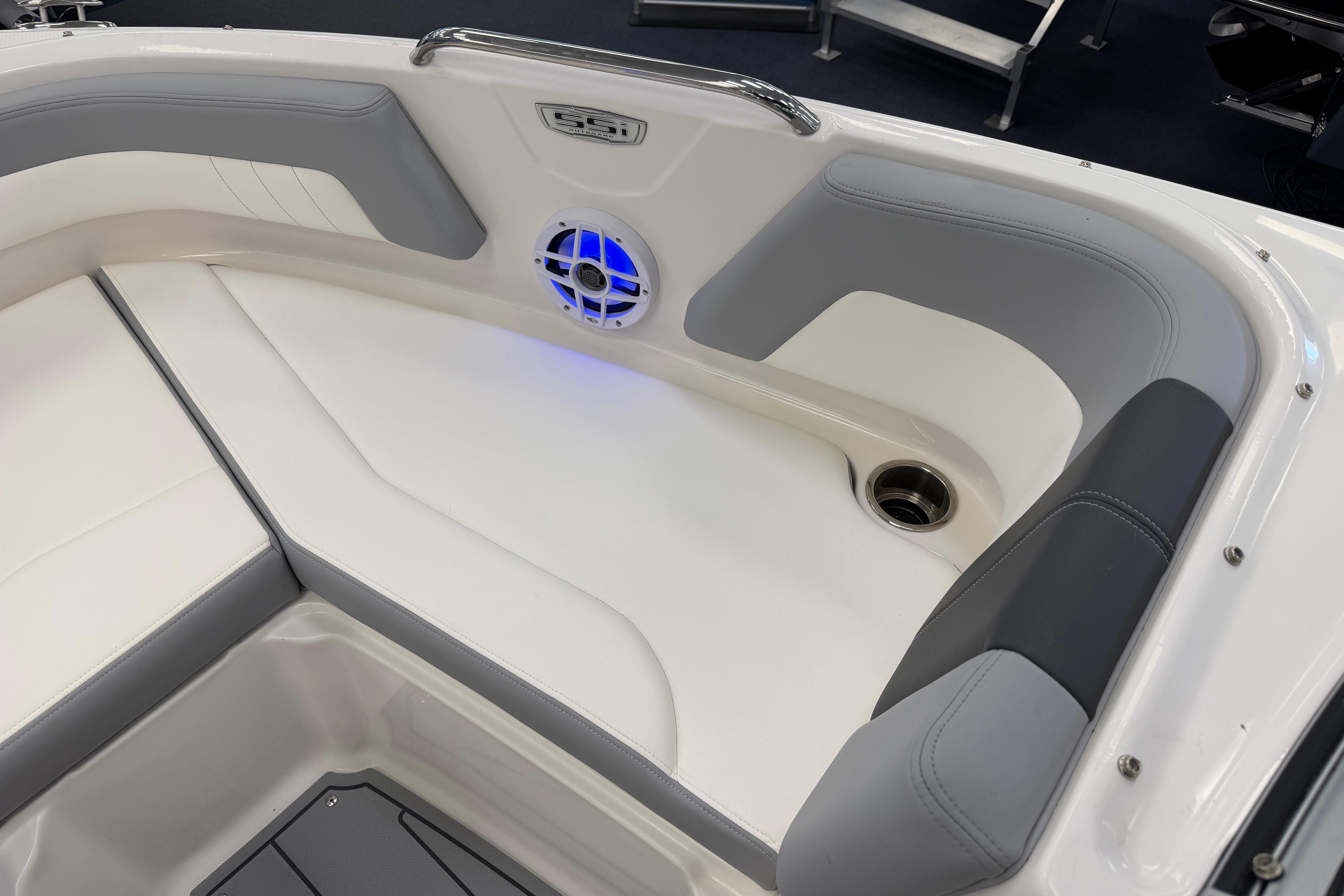 Interior of 2025 Chaparral 21 SSi OB boat with cushioned seating and speaker.