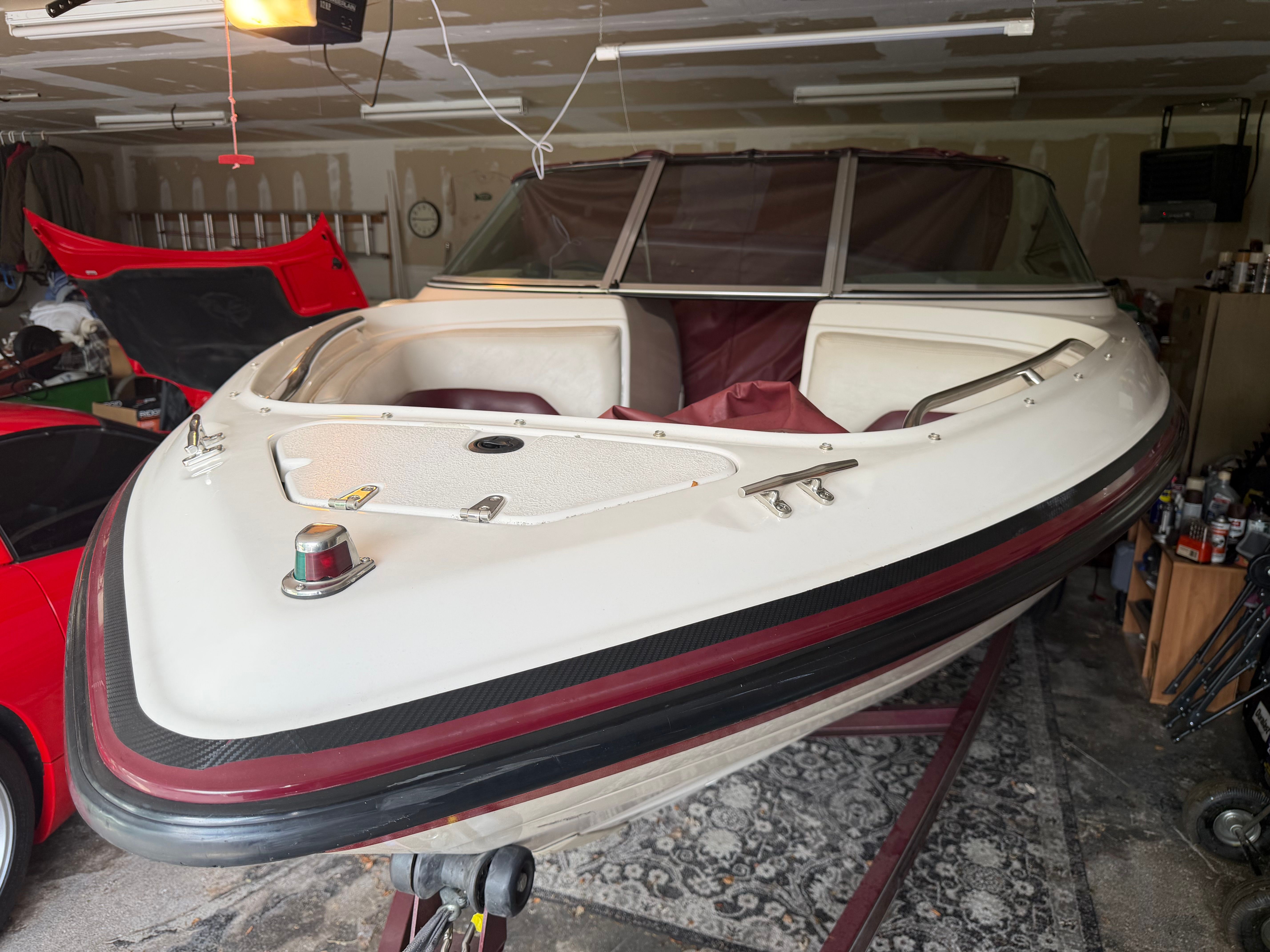 A 1994 Chaparral 1930 boat in a garage. It features a white and red color scheme.