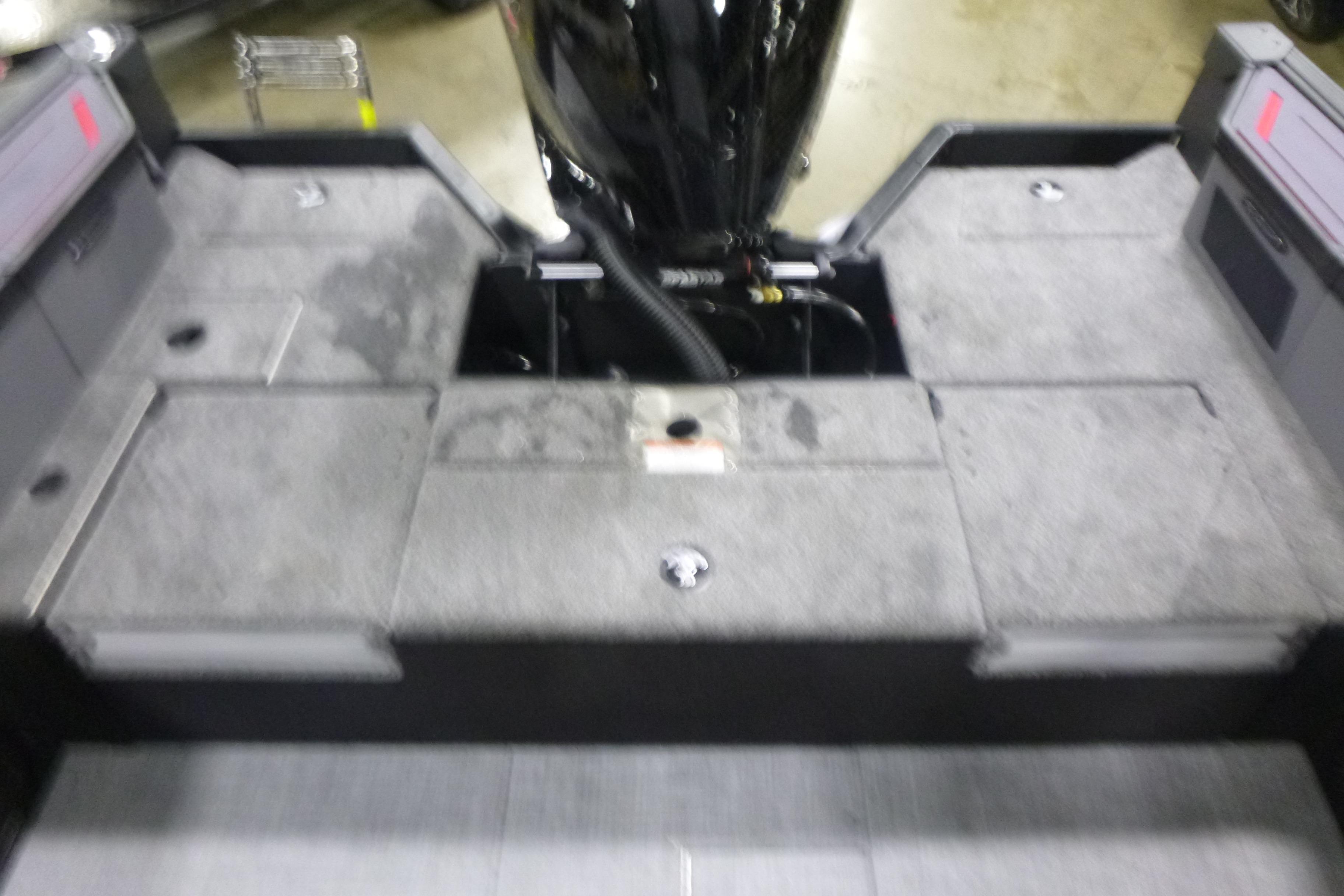 2026 Alumacraft Trophy 205X Sport boat interior with gray flooring and engine compartment.