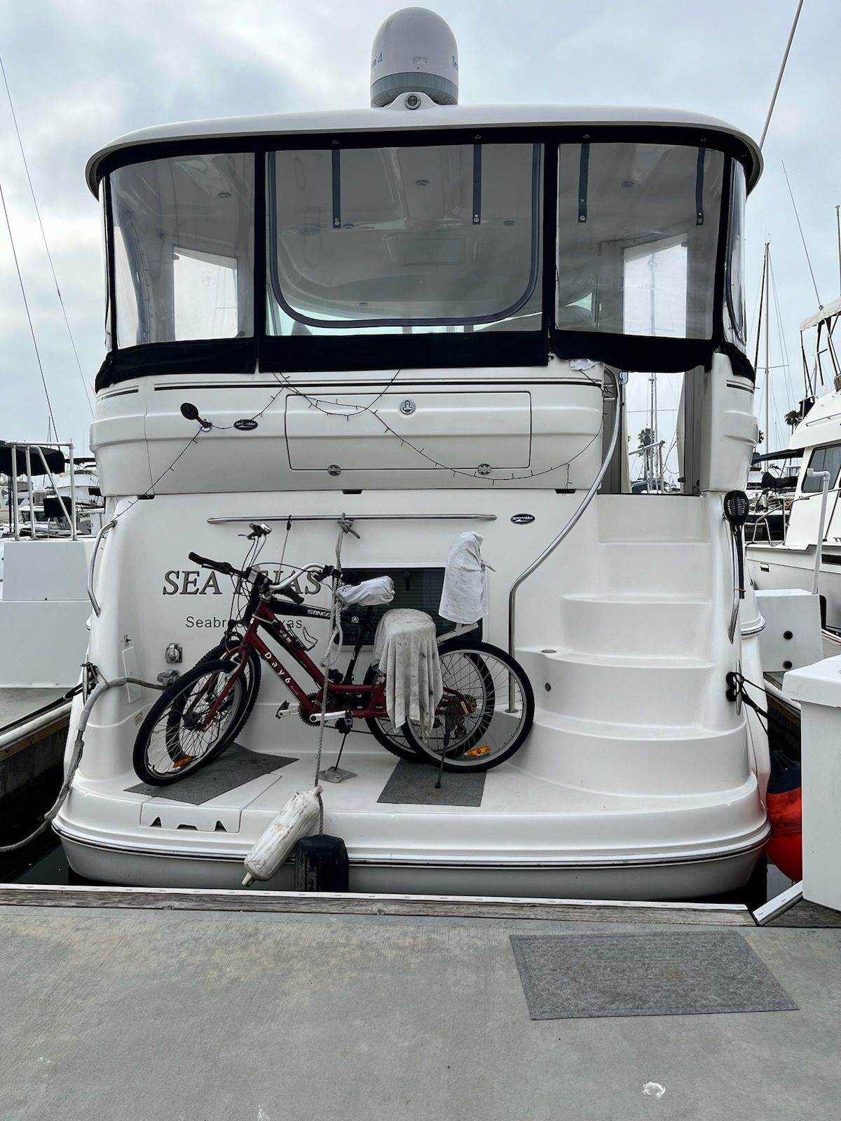 2004 Sea Ray Sedan Bridge at dock with a bicycle on the platform.