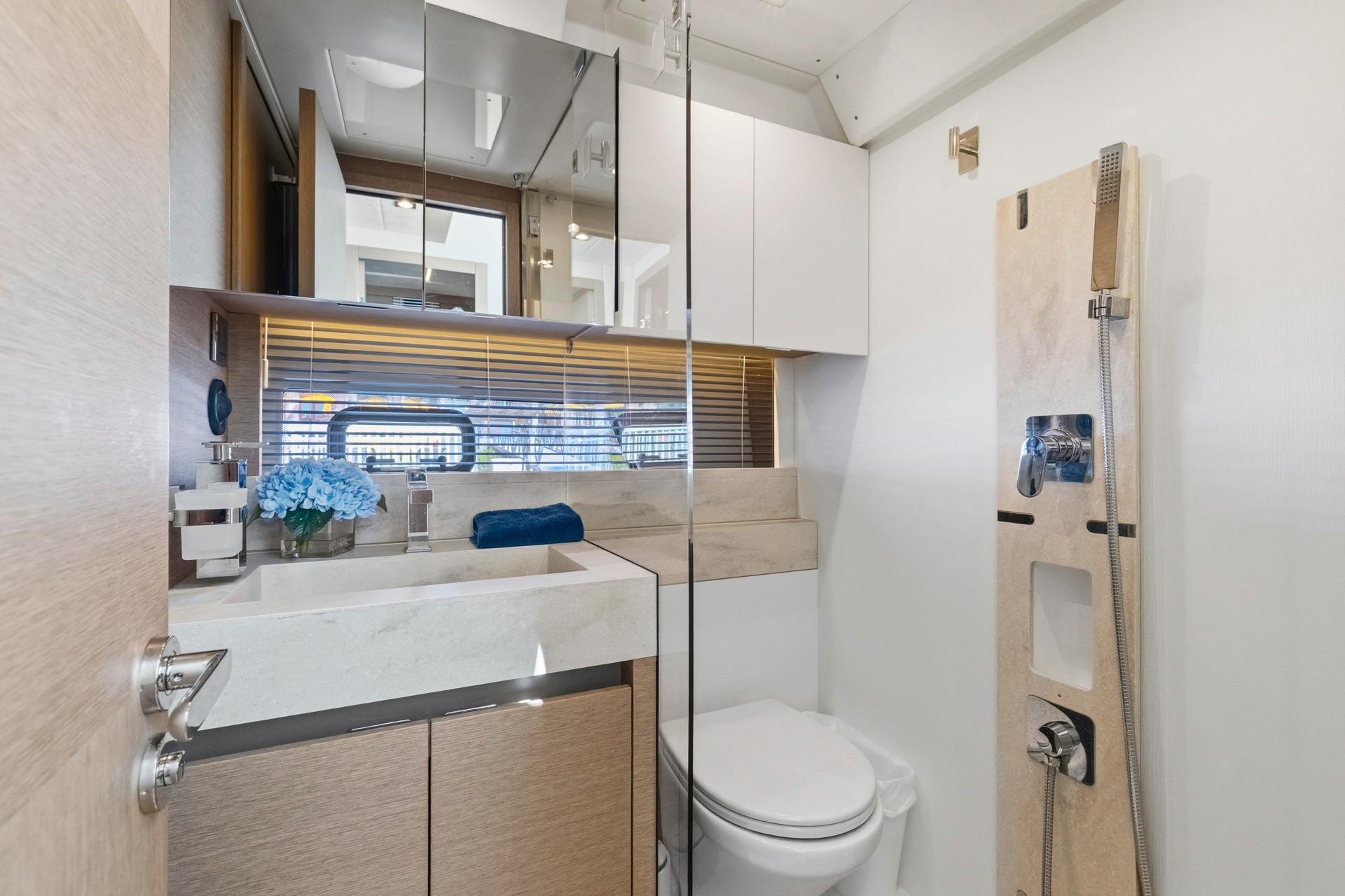 Luxurious bathroom in 2022 Prestige 520 yacht with modern fixtures and elegant design.