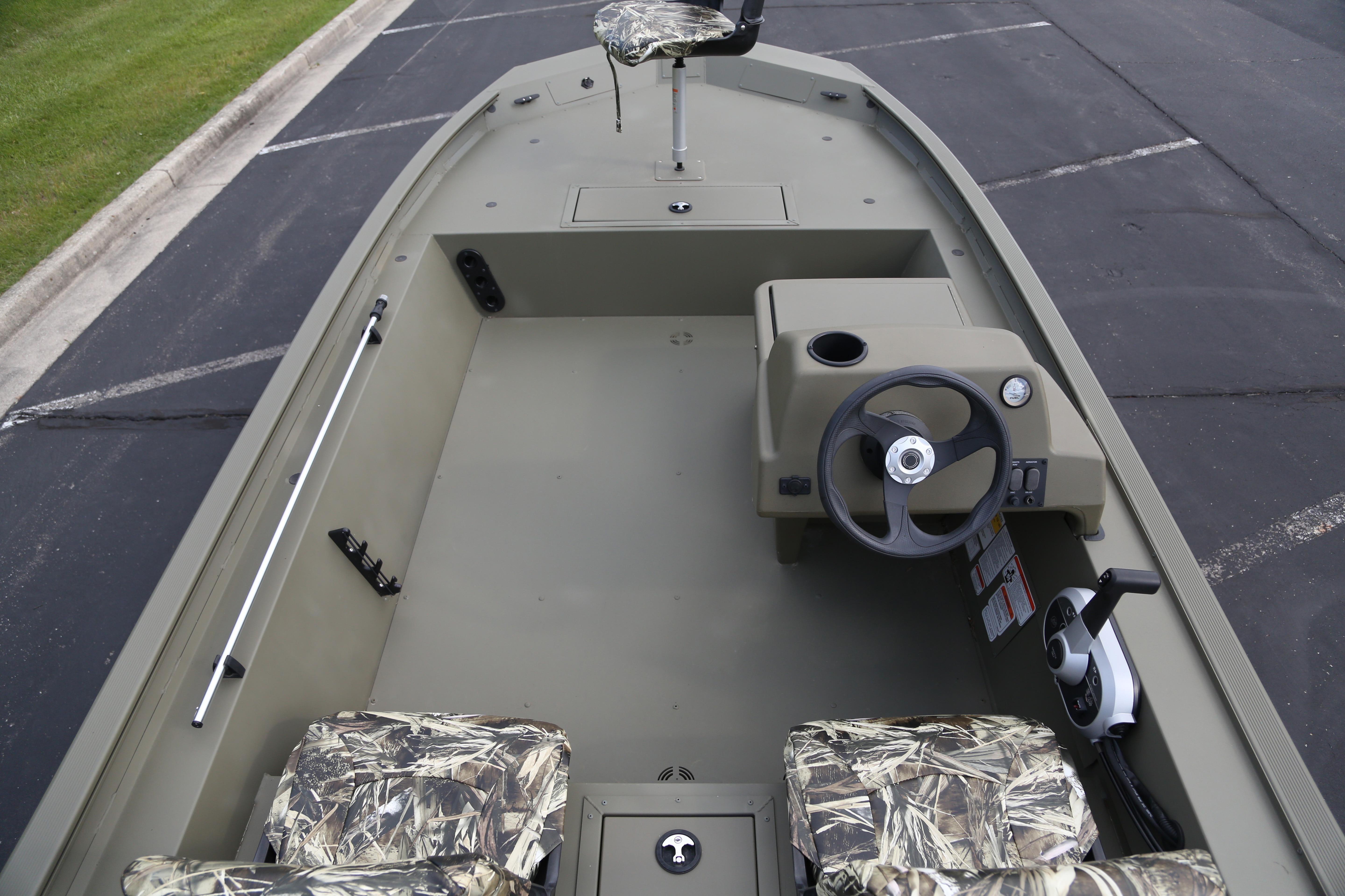 2026 Tracker Grizzly 1754 SC boat interior with camo seats and steering console.