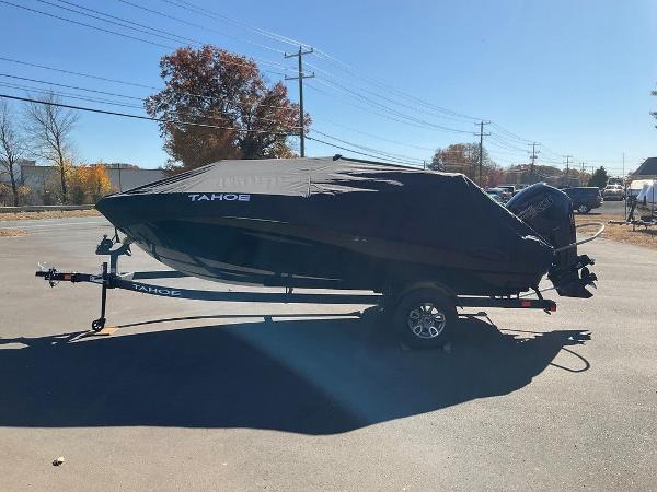 2025 Tahoe T18 boat covered on trailer in sunny outdoor setting.
