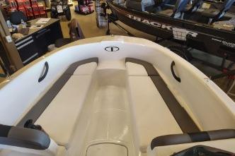 2026 Tahoe T16 boat interior with seating, displayed in a showroom.