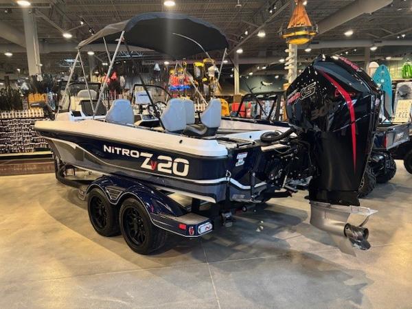 2023 Nitro ZV20 Pro boat displayed indoors with powerful outboard motor.