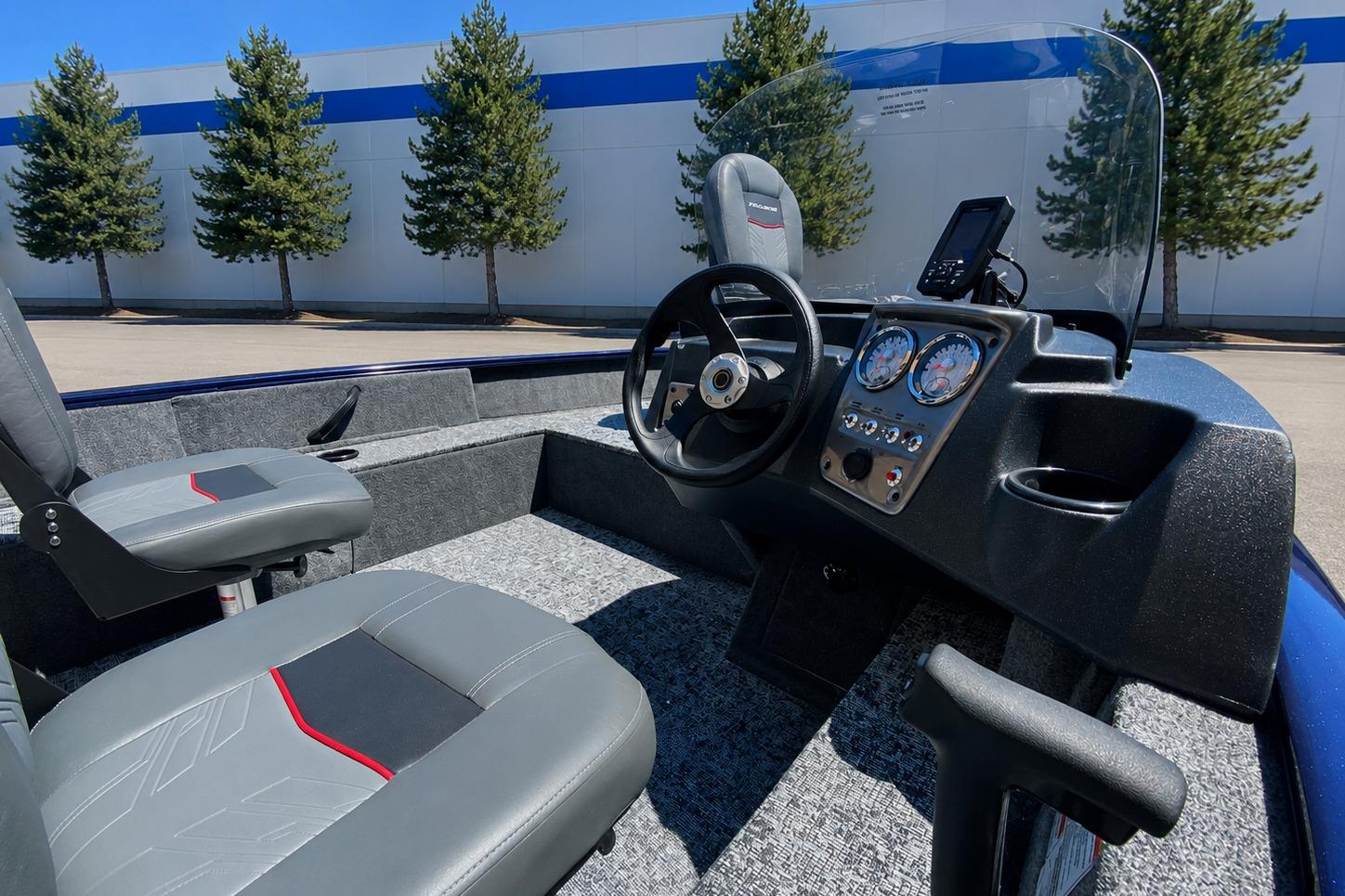 2026 Tracker Pro Guide V-16 SC boat interior with steering console and seating.