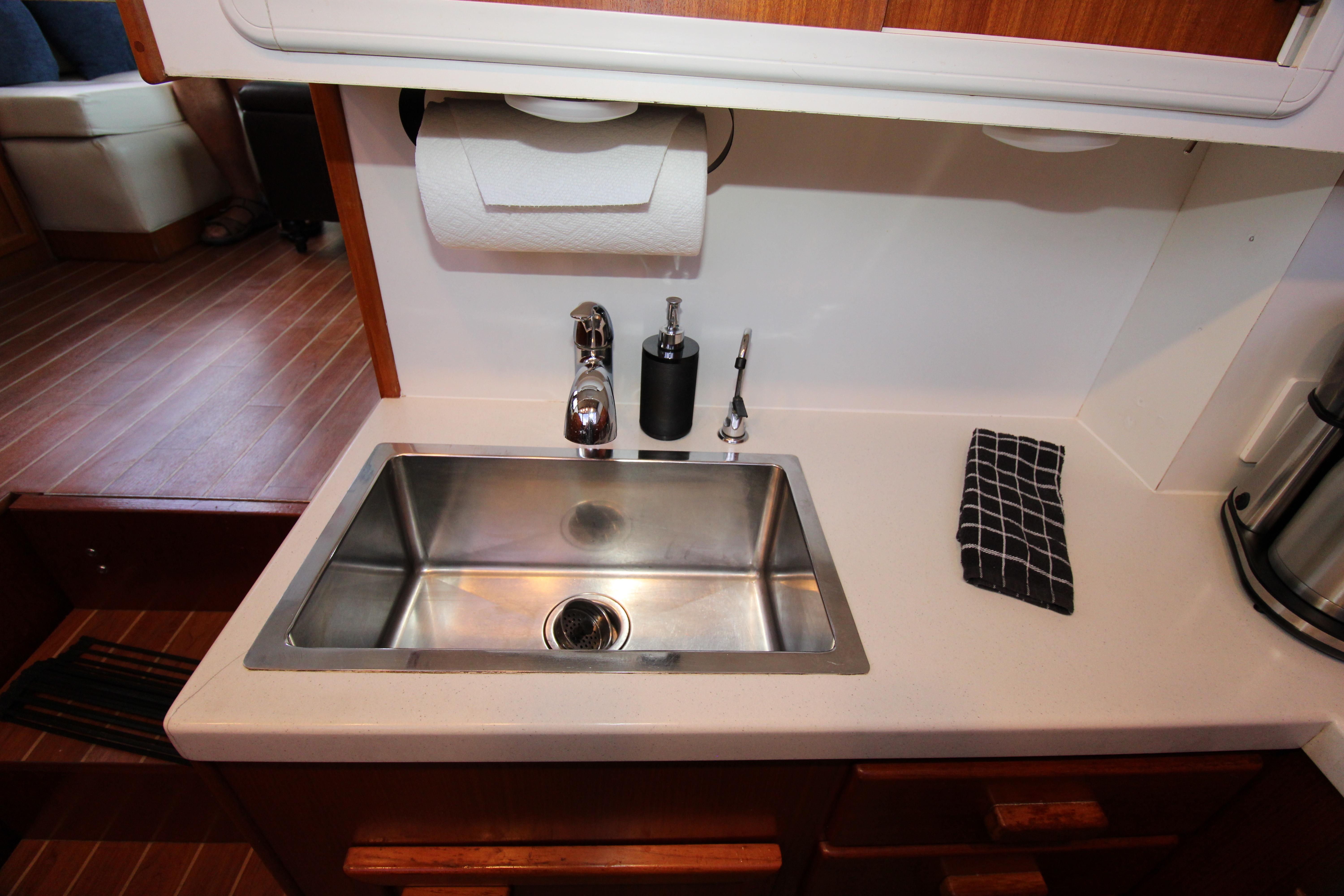 Ricker 42 Classic 2000 yacht kitchen sink with modern fixtures and countertop.