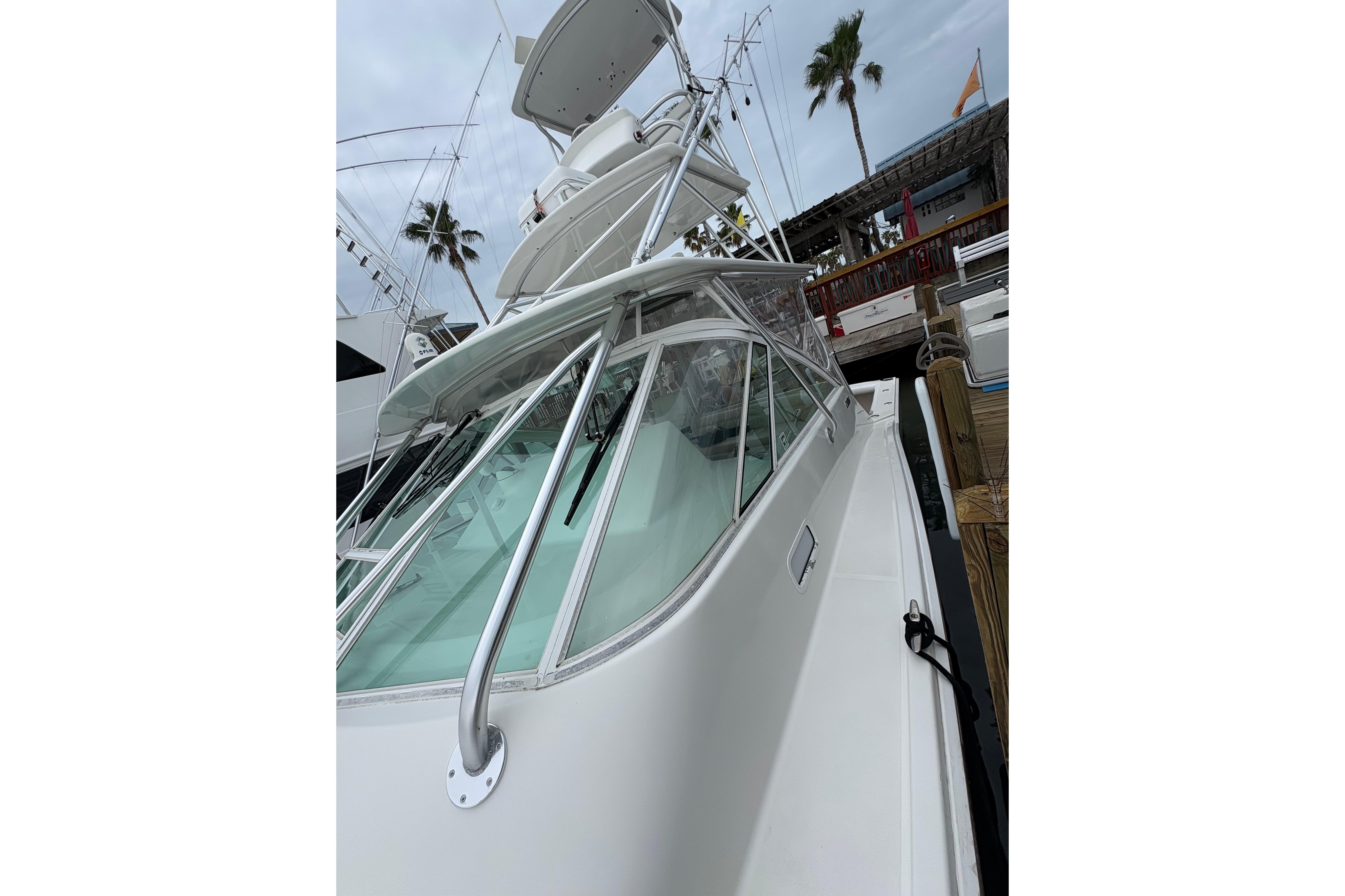 2004 Cabo 40 Hardtop Express yacht docked, showcasing sleek design and modern features.
