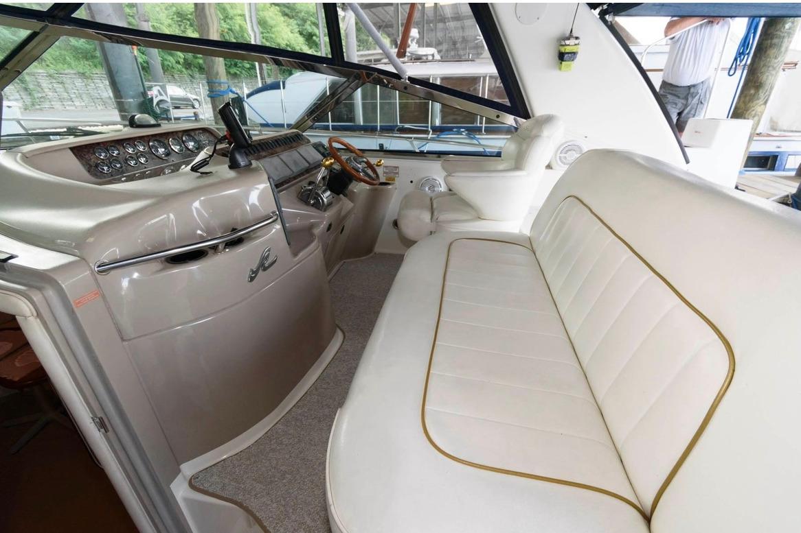 Interior of a 1999 Sea Ray Sundancer 400 yacht with plush seating and sleek dashboard.